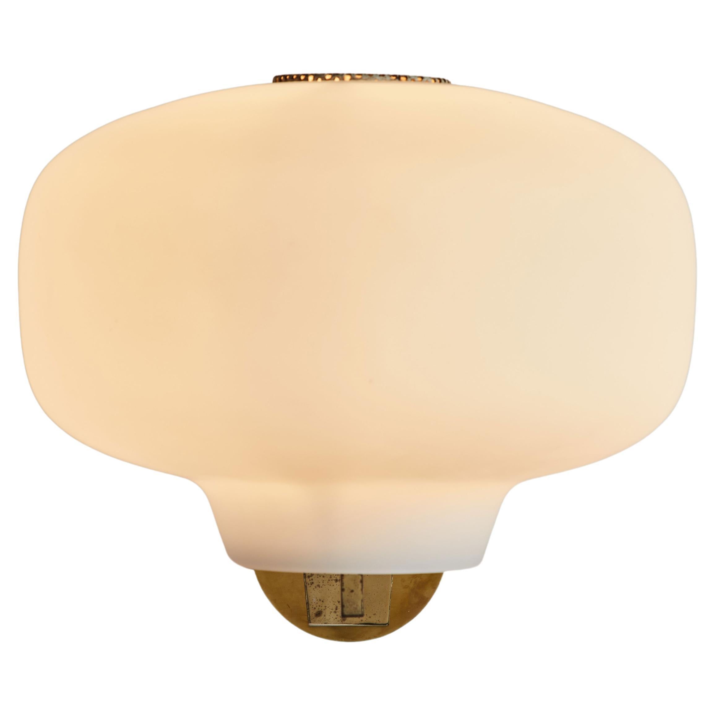 Stilnovo opal wall light manufactured in Italy, circa 1960s. Perforated metal armature brushed satin glass shades and brass hardware. Wired for US junction boxes. Takes one E27 100w maximum bulb. Retains original manufacturer's label.