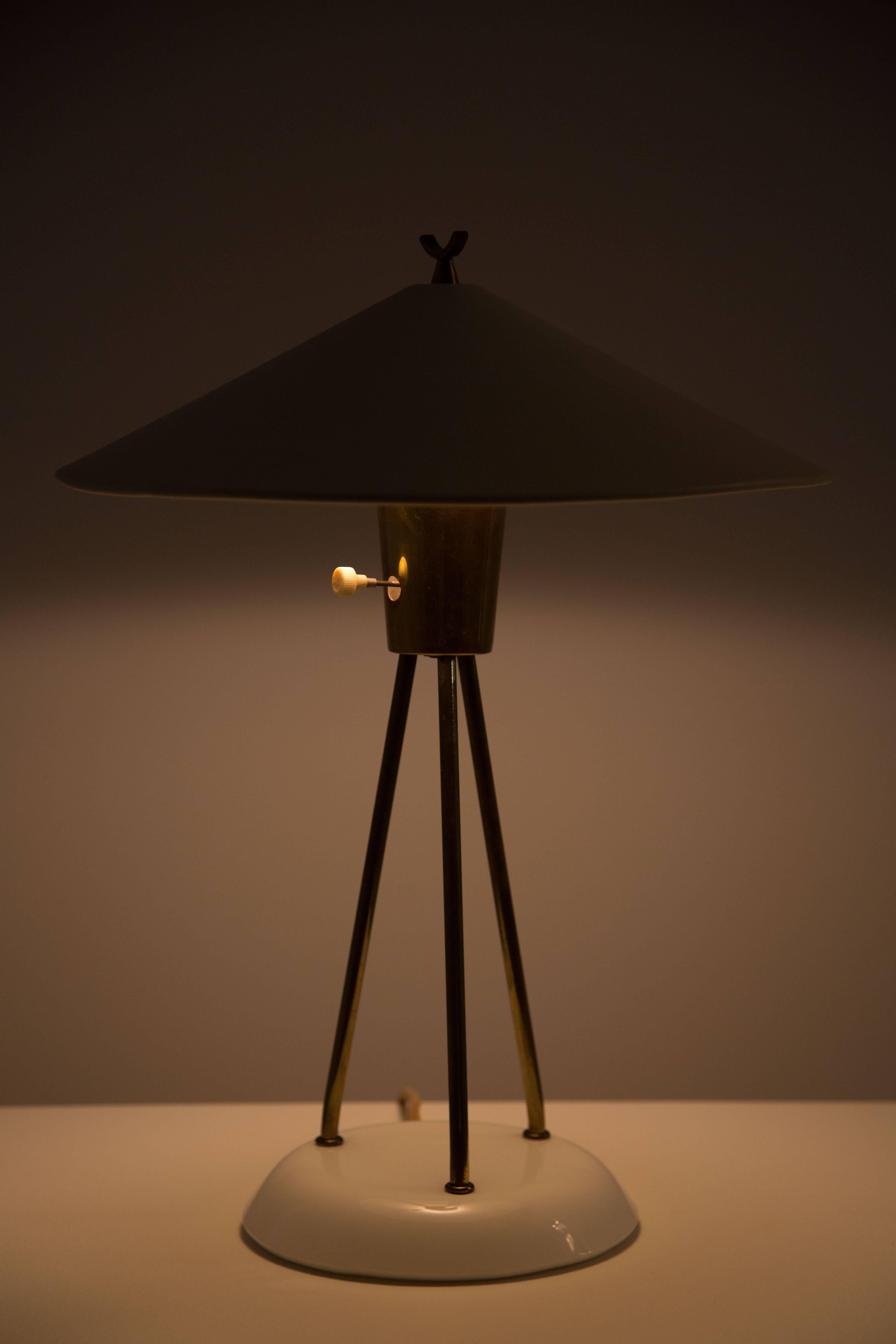 Brass and metal table lamp with fully pivoting shade.