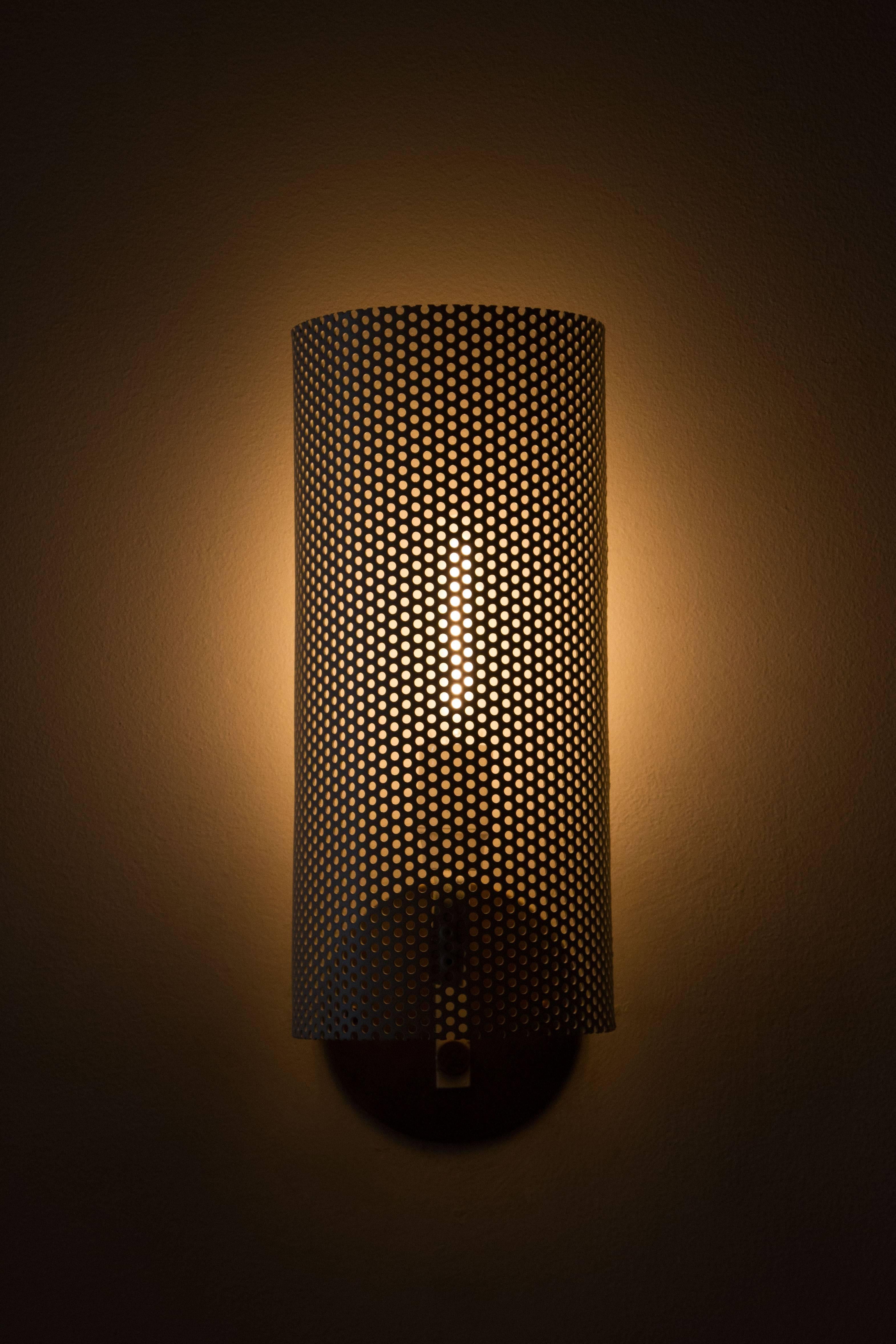 Fully restored perforated sconces.
