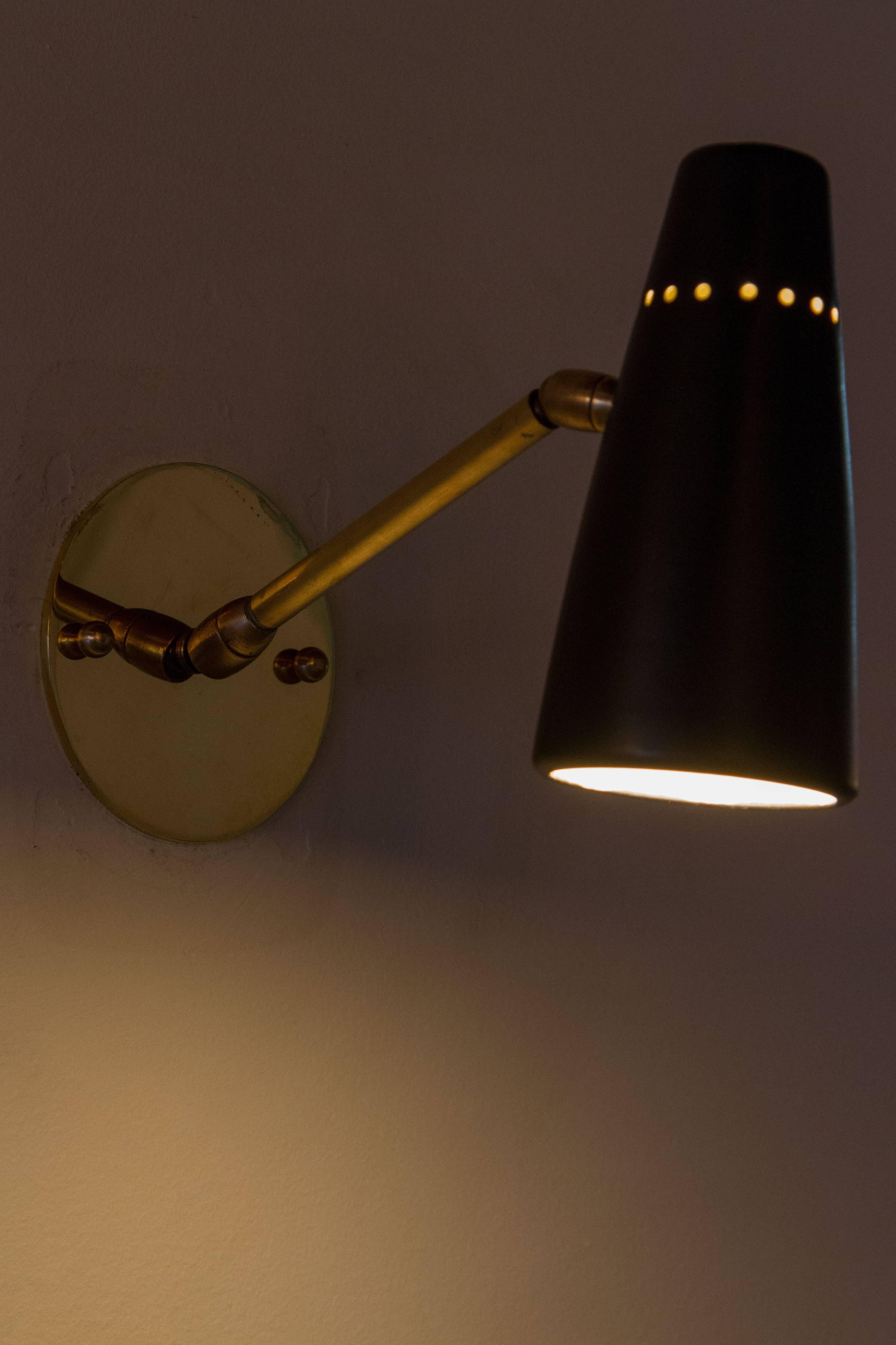 Brass and metal sconces with pivoting stem and shade.