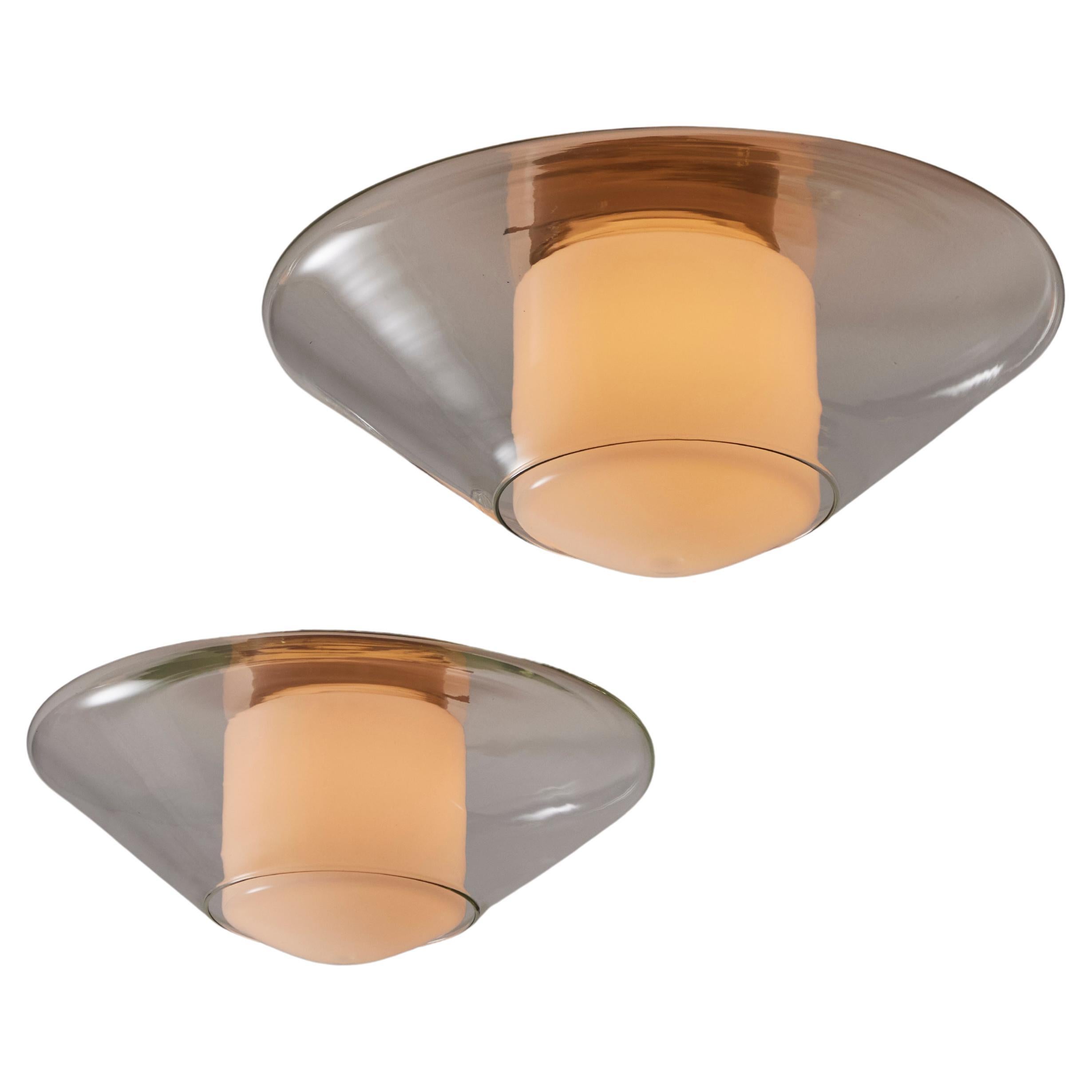 Single Flush Mount by Oluce. Designed and manufactured in Italy, circa the 1960s. The glass flush-mount comprises of a  clear blown glass outer cone and an interior opal glass cylindrical diffuser. The light holds a single E27 socket type, adapted