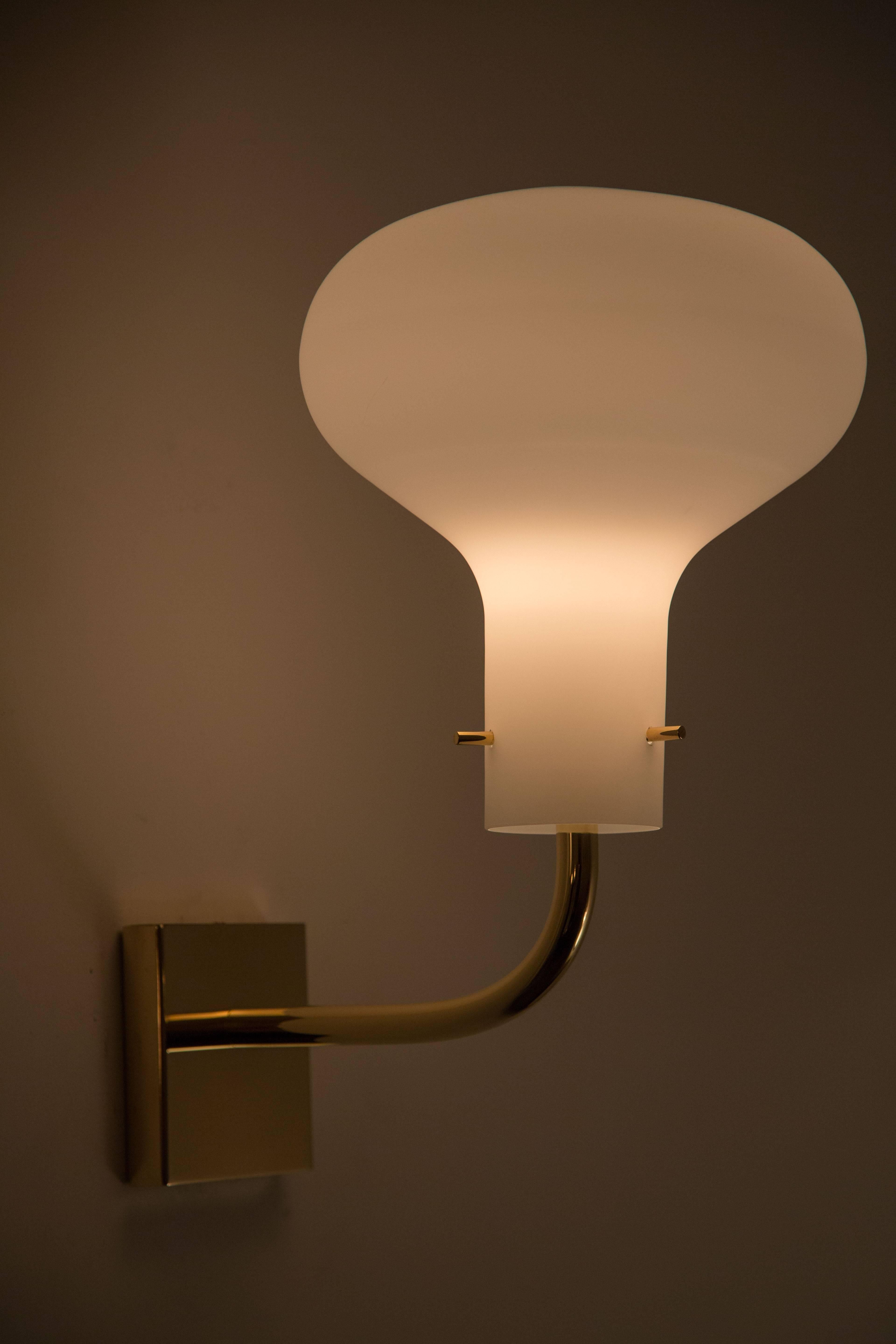 Brass and opaline glass wall light originally manufactured in 1958.