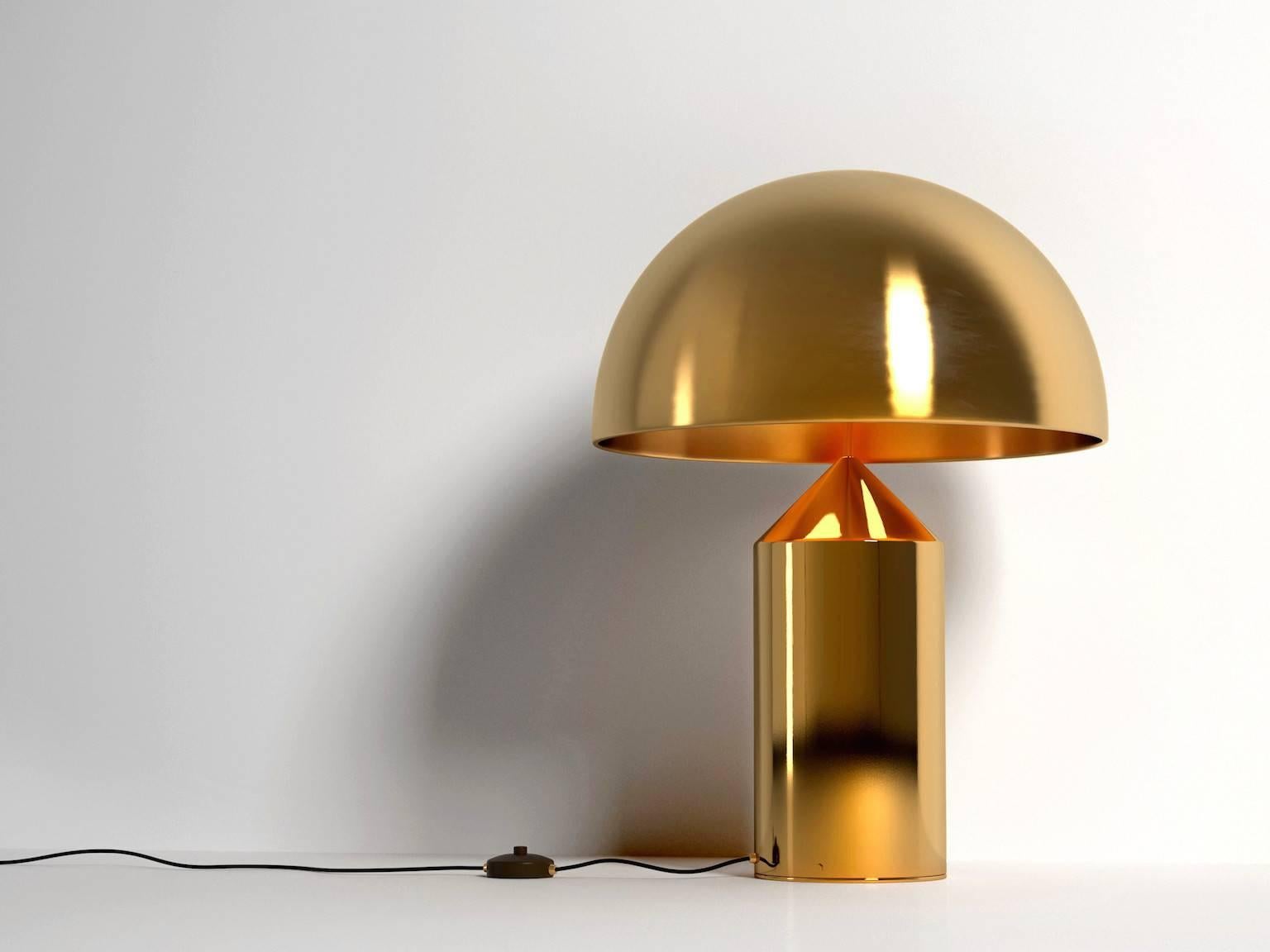 Iconic Atollo model 239 table lamp originally designed by Vico Magistretti for Oluce in 1977. This current production provides direct light as a table or bedside lamp. Comes in a gloss black painted aluminum finish or satin gold galvanic finish or