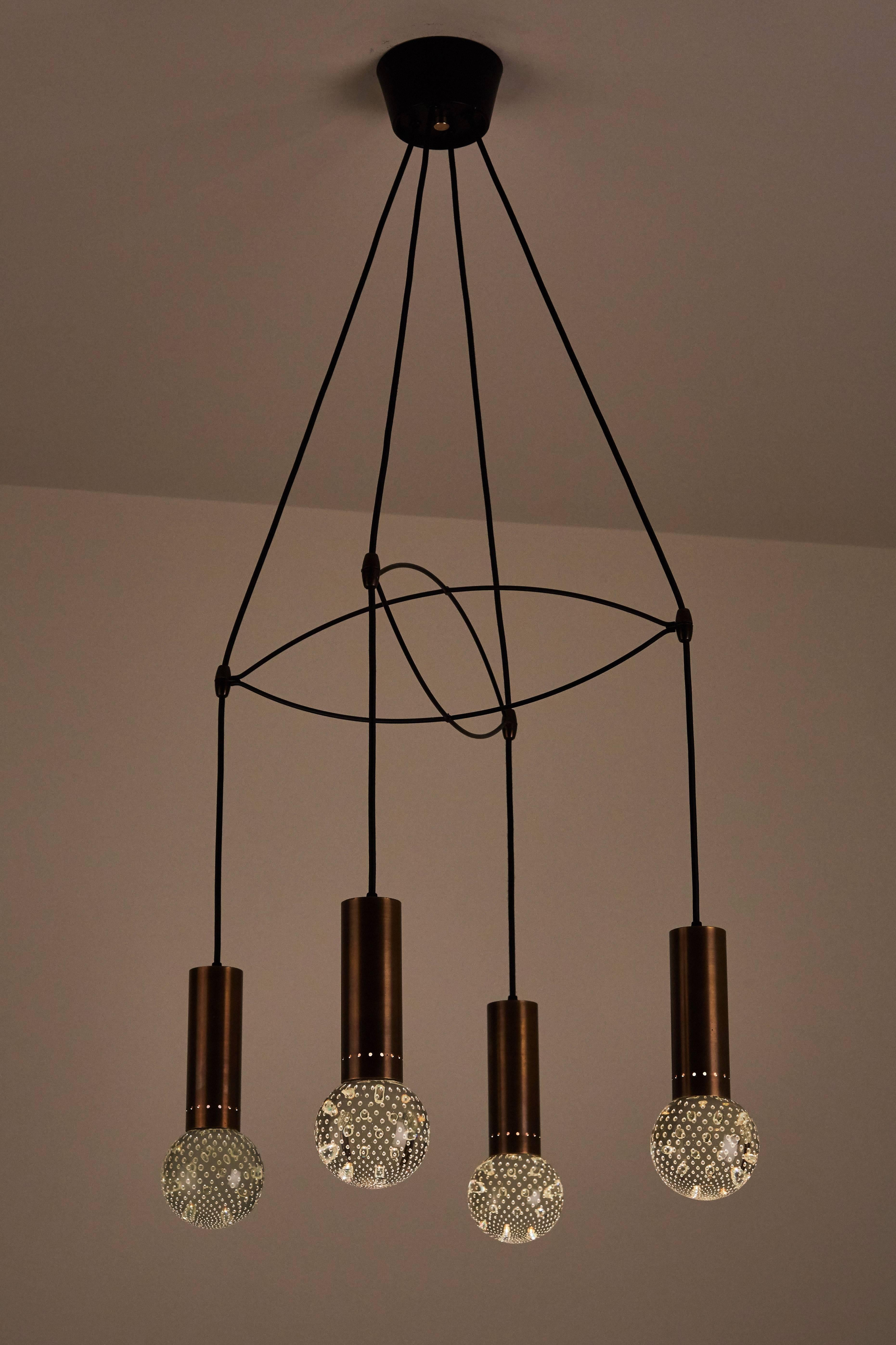Italian four globe suspension light handblown glass, brass, enameled steel and rubber. Designed in Italy circa 1950s. Original canopy. Wired for us junction boxes. Each globe takes an e14 60 W maximum bulb.
   