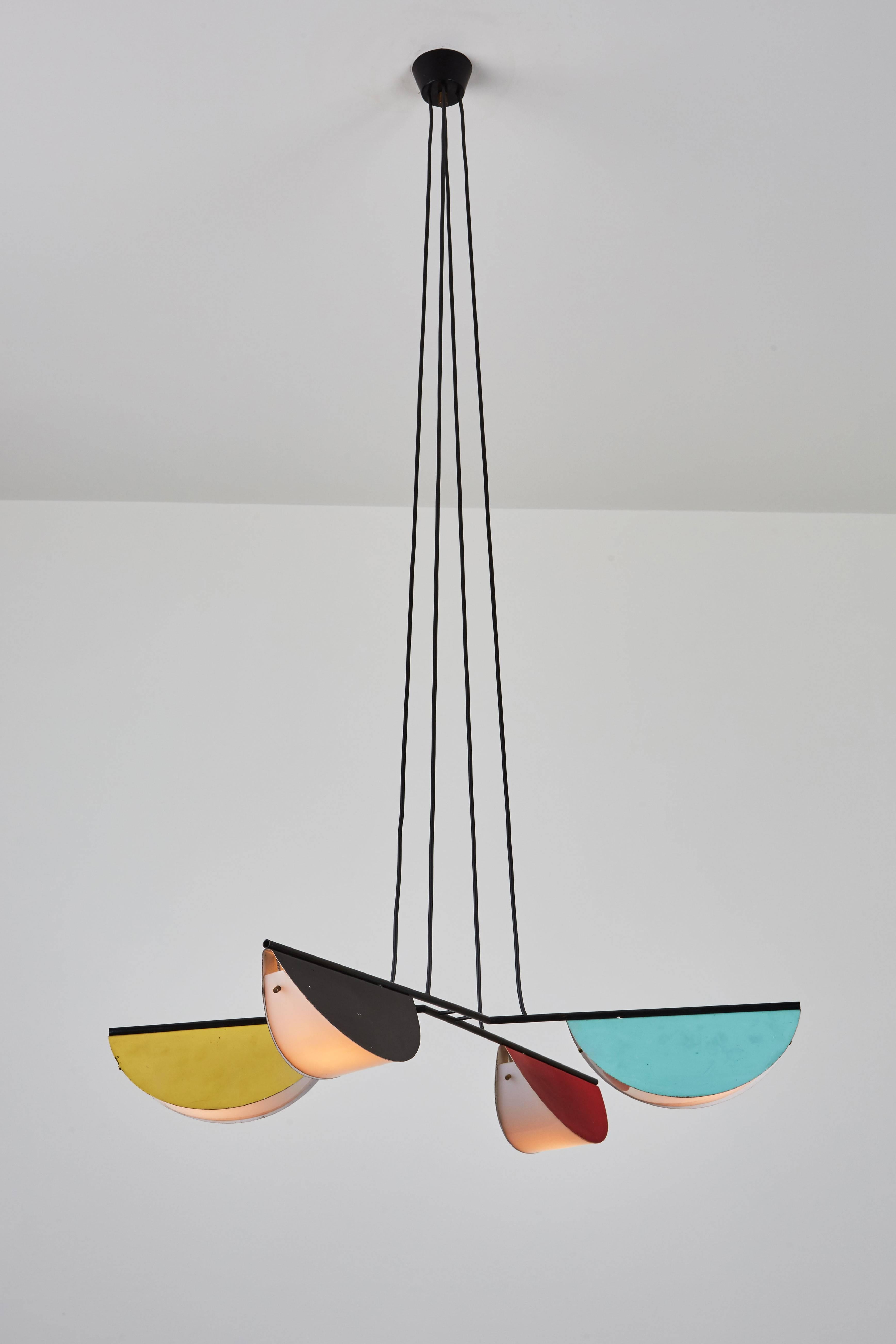 Italian chandelier with four individually colored shades. Painted metal and acrylic with brass hardware. Original canopy. Rewired for US junction boxes. Each shades takes an E26 40 W maximum bulb. Overall drop can be adjusted.