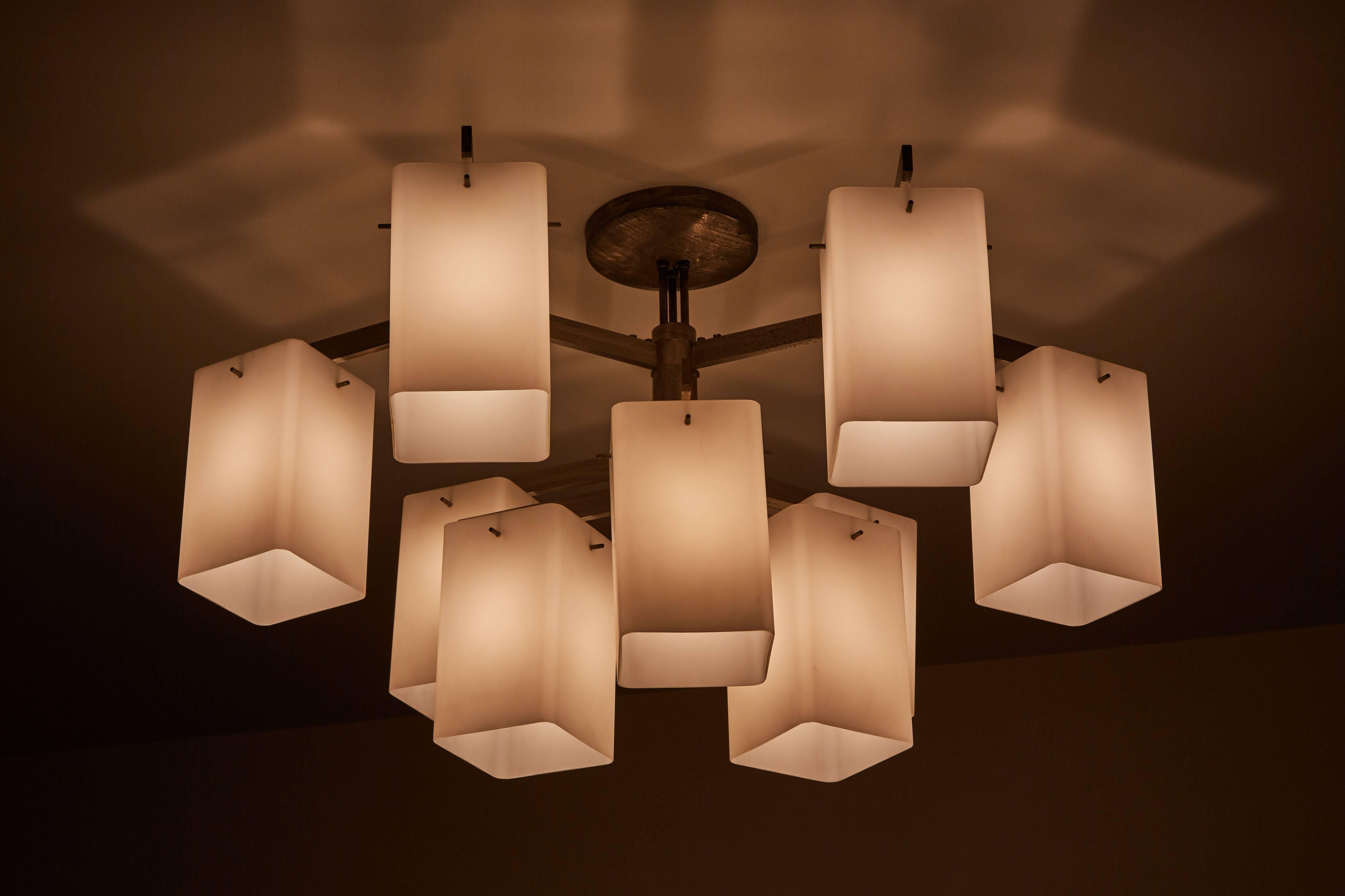 Rare chandelier with nine rectangular brushed satin glass shades and nickel plated brass. Designed by Stilnovo in Milan, circa 1960s. Takes 9 E27 40w maximum bulbs. Wired for US junction boxes.