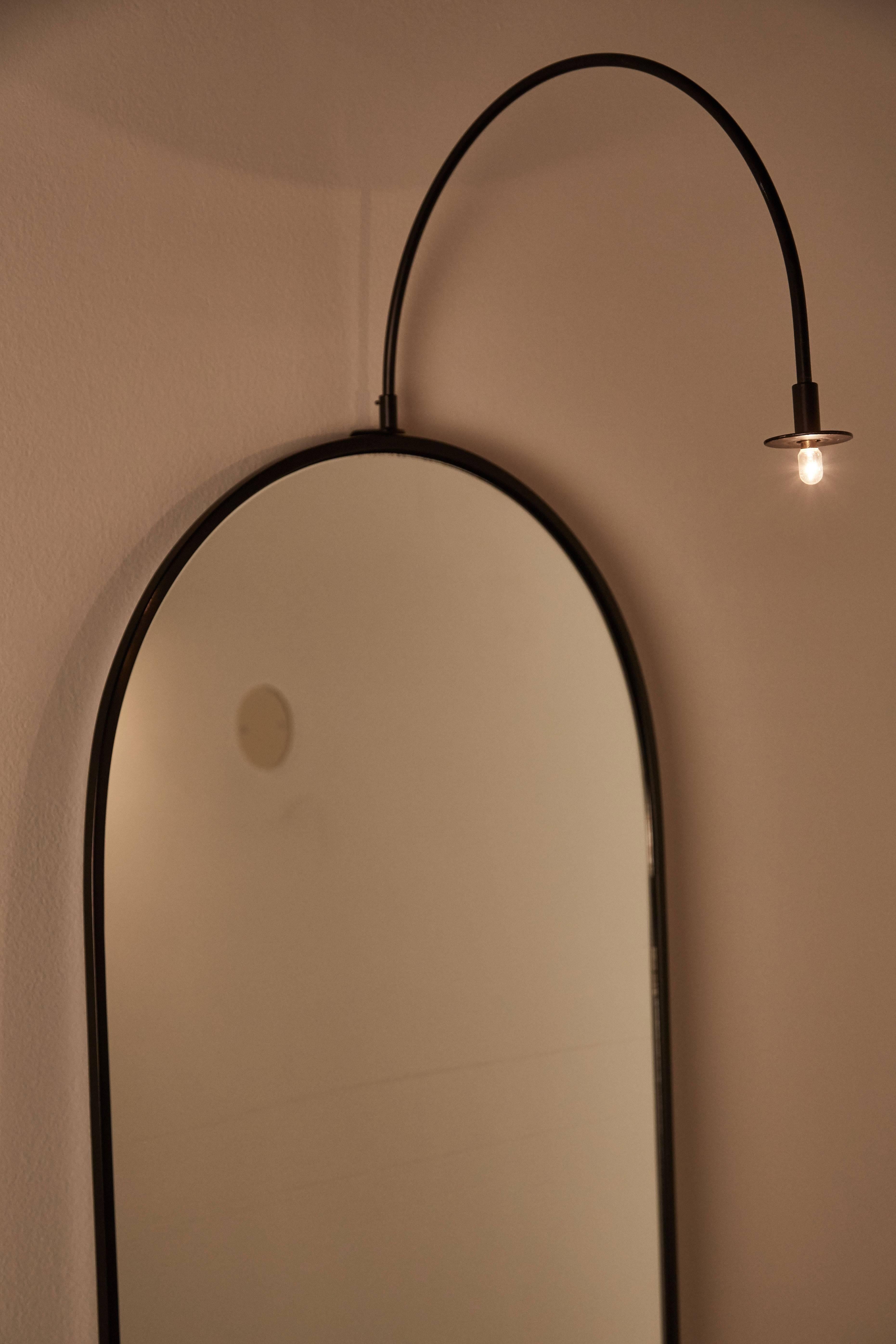 Illuminating mirror designed by Carlo Forcolini for Alias in Italy, 1982. Small switch located in the middle of fixture allows mirror to be illuminated. Glass and steel. Battery operated with one G9 halogen bulb.