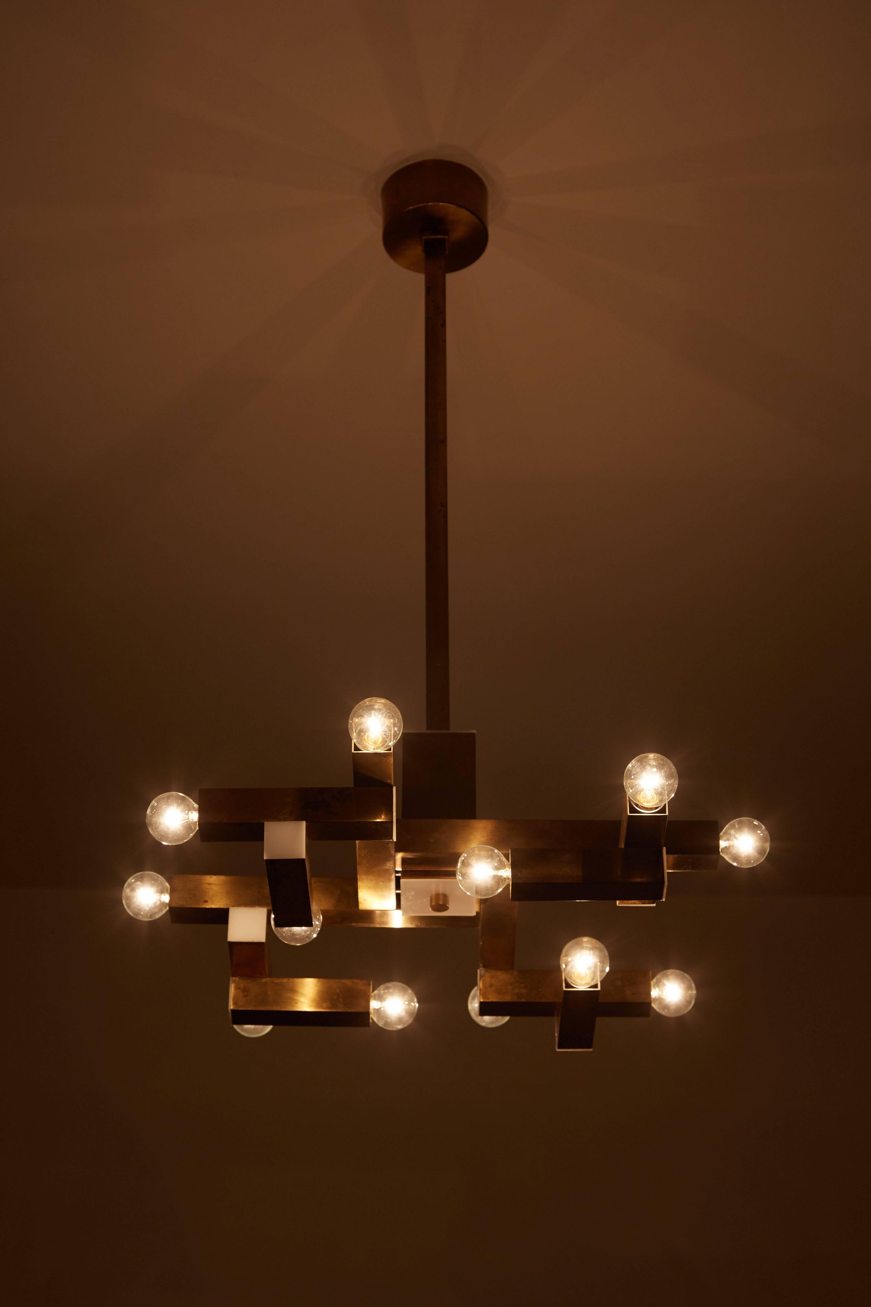 Italian brass chandelier manufactured by Lumi in Italy, circa 1960s. Twelve squared hollow brass tubes with acrylic accents. Wired for US junction boxes. Each tube takes one E14 15w maximum bulb.