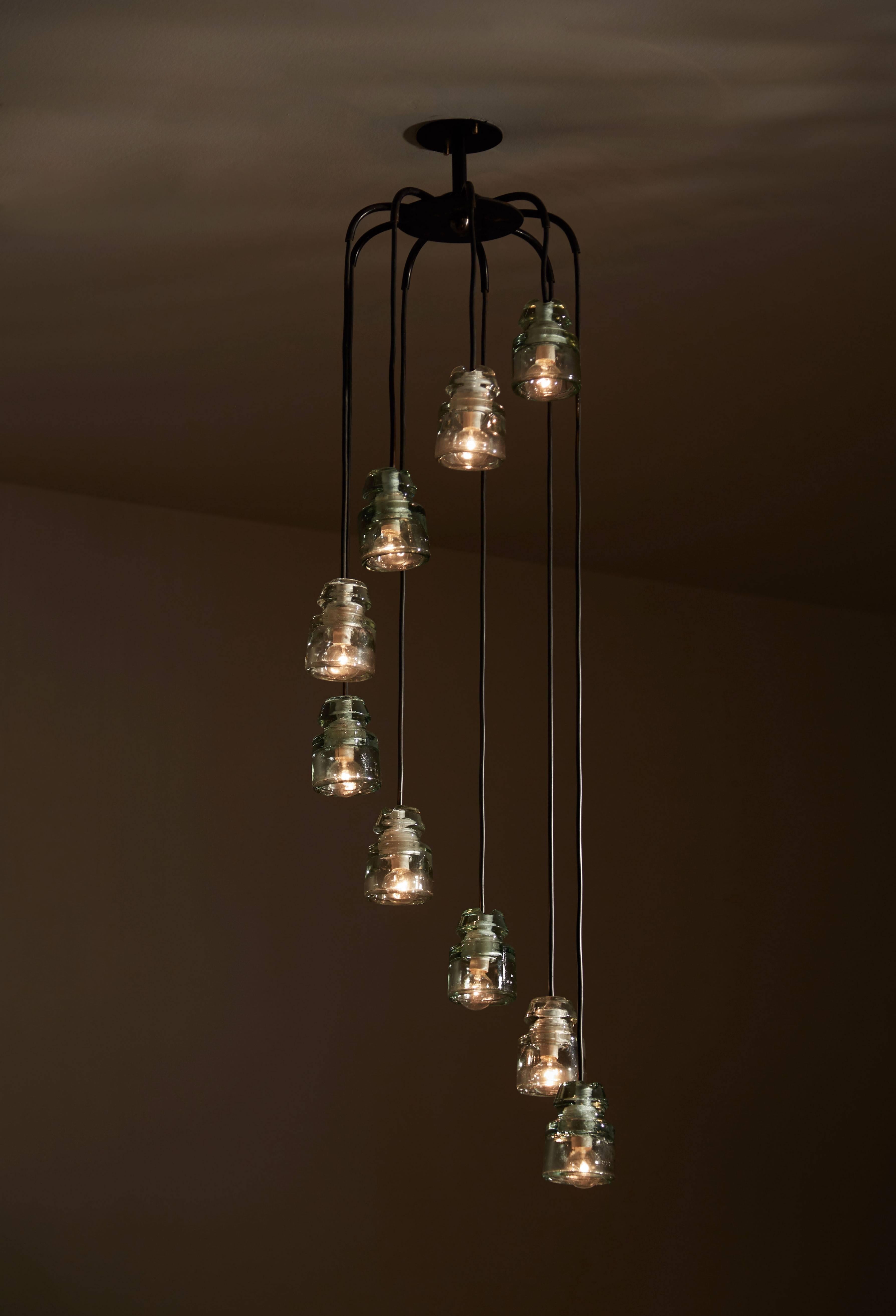 Cascading chandelier with nine moulded glass transformers. Designed by Tito Agnoli for Oluce in the '60s in Milan.  Can be paired with our other Tito Agnoli Chandelier as a unique pair. Please see reference# LU79477016163.  Painted metal and glass.