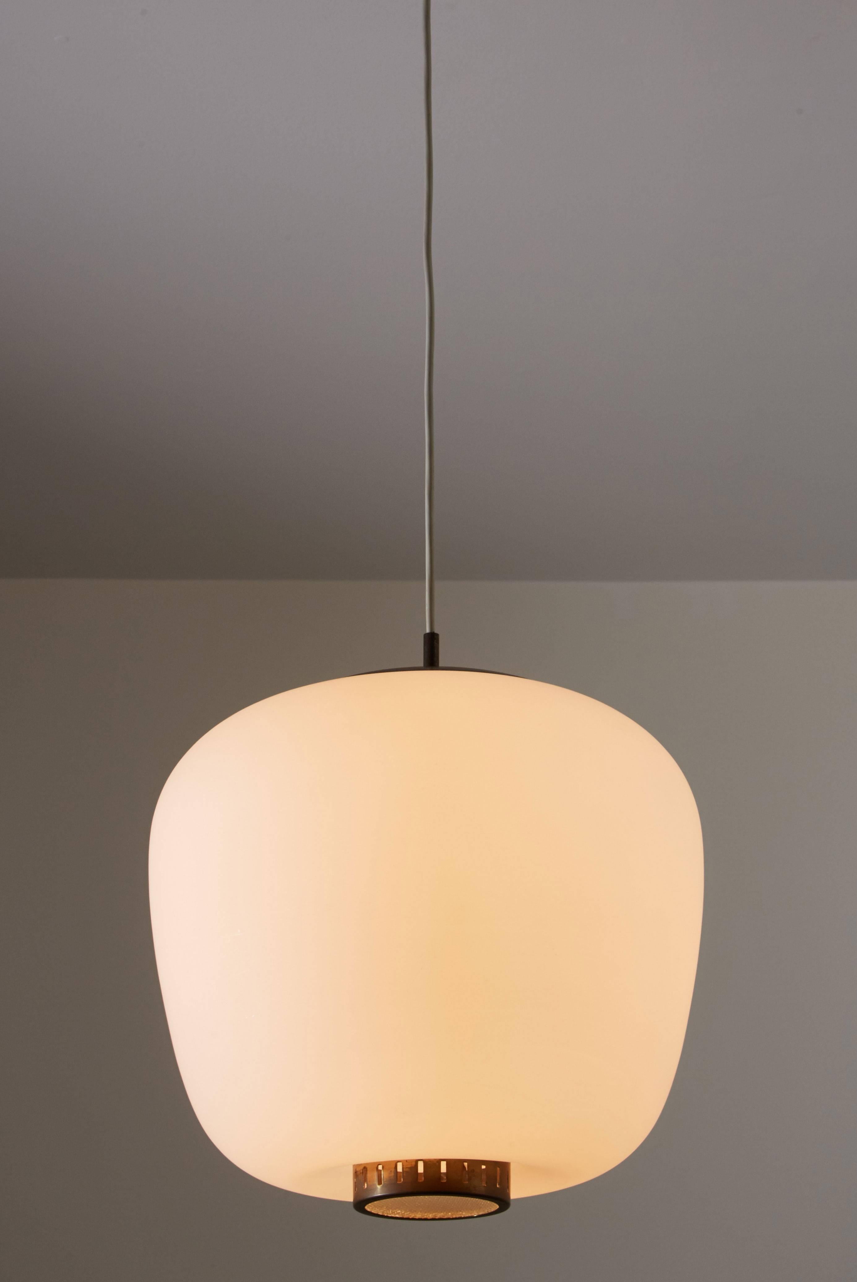 Brass and satin glass pendant by Stilnovo. Designed in Italy, circa 1950s. Original canopy with custom brass backplate. Overall drop can be adjusted. Height displayed is for fixture only. Rewired for US junction boxes. Takes one E27 100w maximum