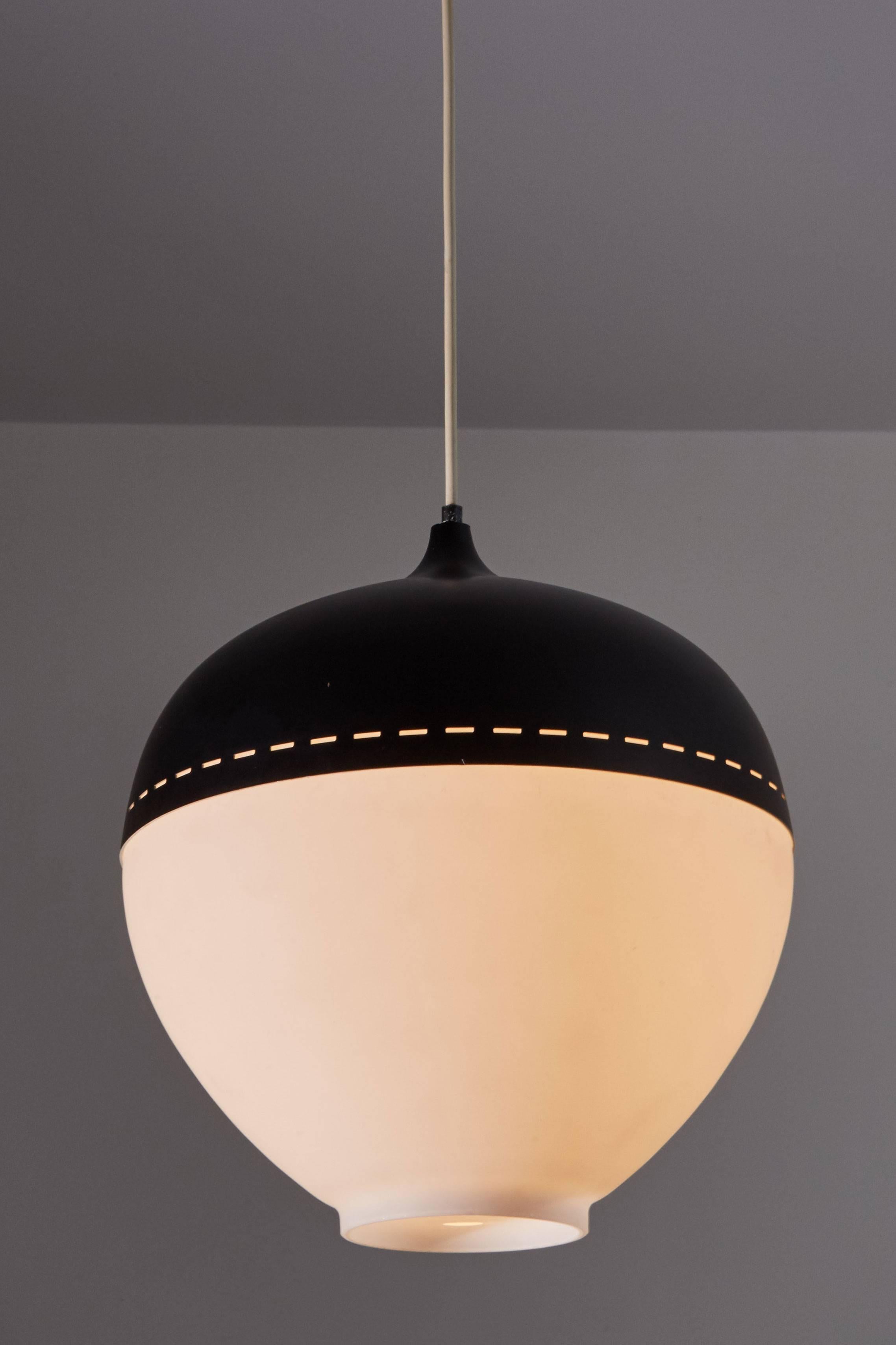 Satin glass and perforated metal pendant by Stilnovo designed in Italy, circa 1950s. Retains original label. Custom backplate. Wired for US junction boxes. Takes one E27 100w maximum bulb.