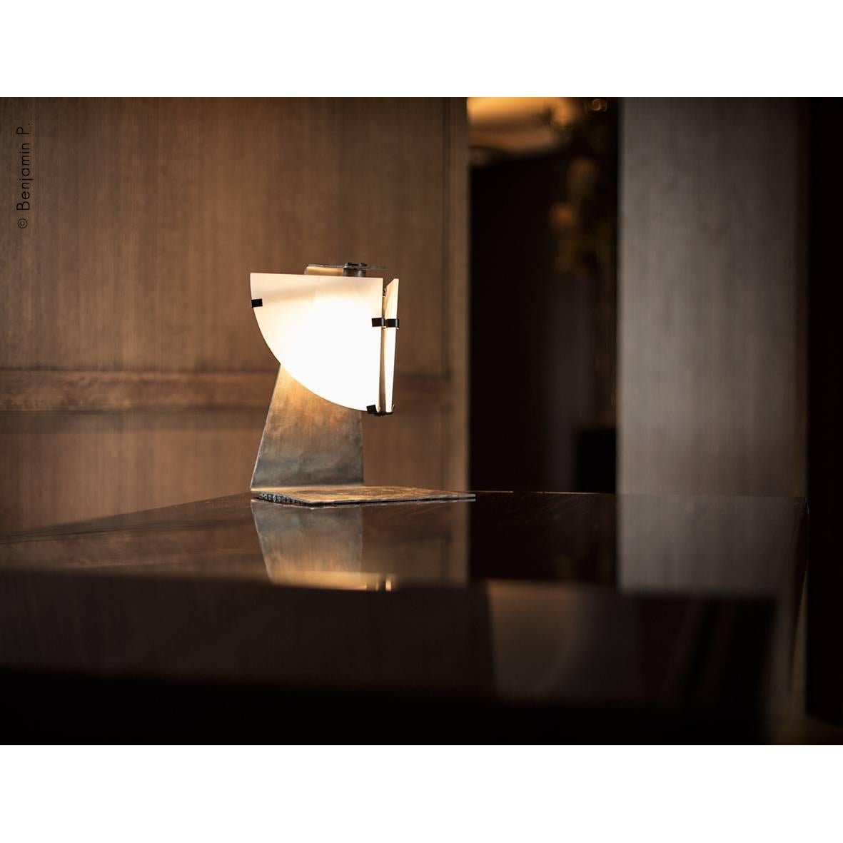 Quart de Rond table lamp originally designed  by Pierre Chareau in France, 1922. Current production by Galerie MCDE. Composed of two panels of alabaster in quarter-wedges adjustable. Base in forged blackened metal and darkened wrought iron and
