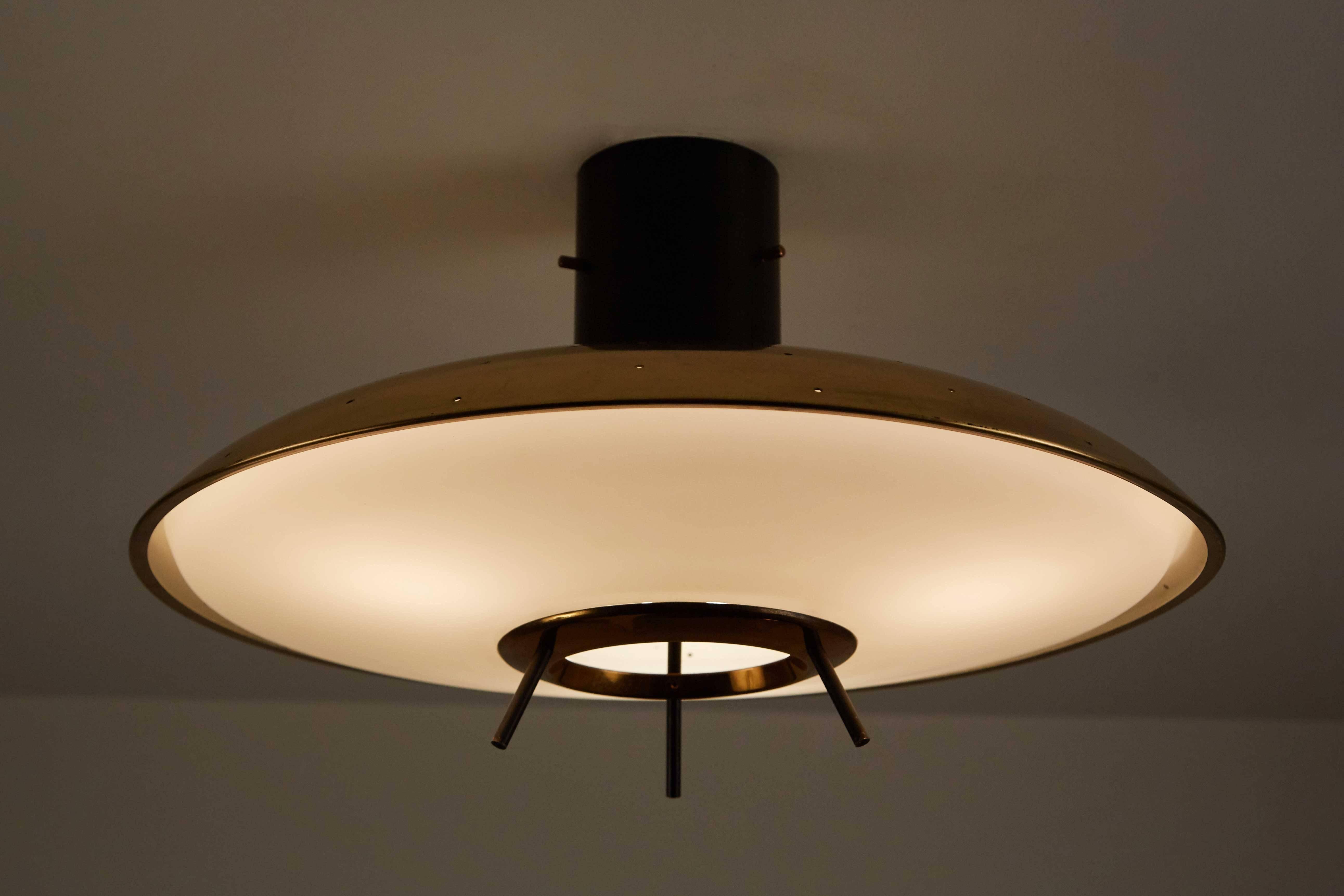 Original Stilnovo brass and satin glass flush mount ceiling light designed in Italy, circa 1950s. Wired for US junction boxes. Takes three E16 60w maximum bulbs. Retains original Stilnovo label.