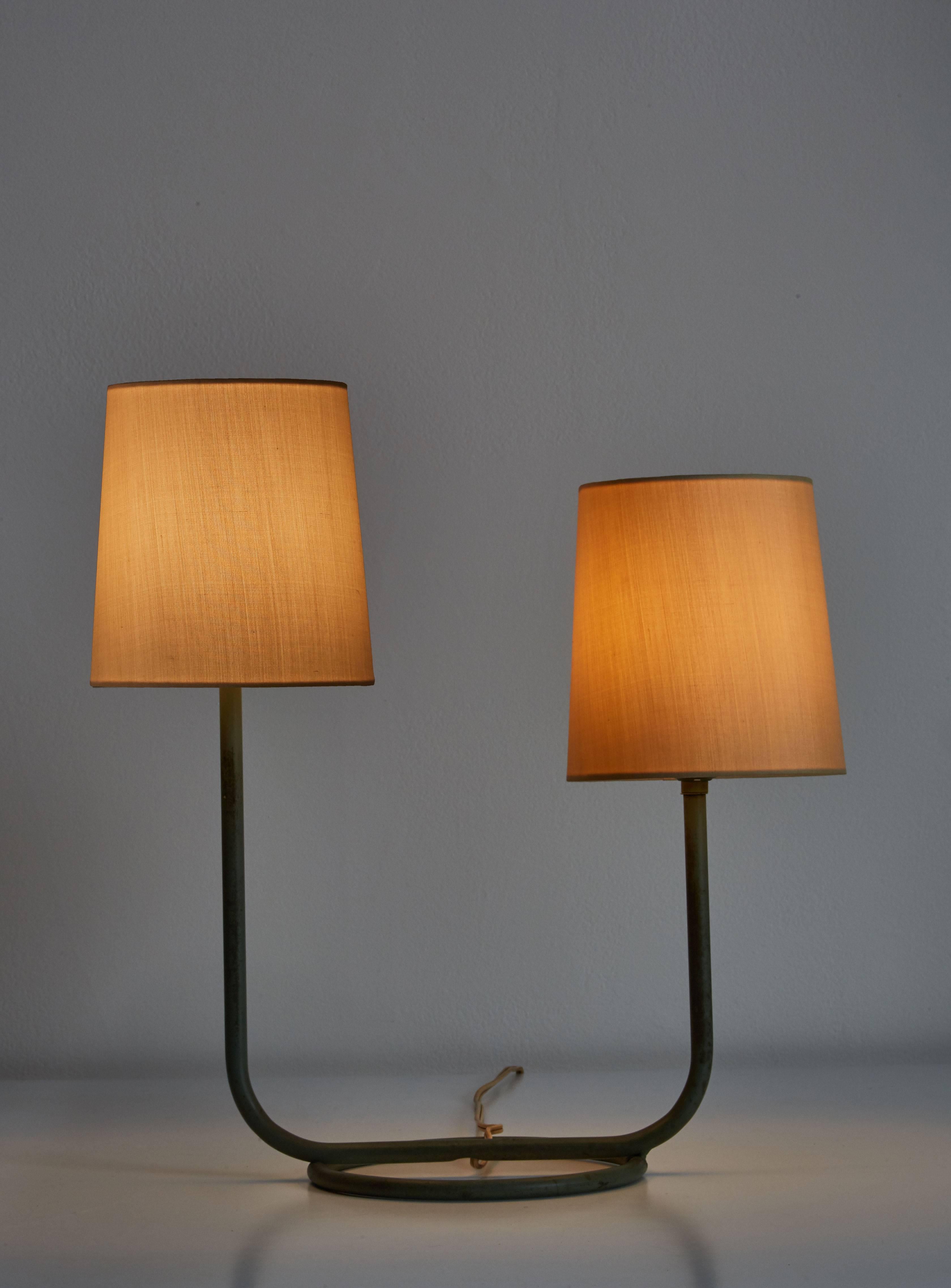 Double arm table lamp by Kurt Versen designed in the US, circa 1950s. Custom silk shades. Original cord and paint. Takes two E26 60w maximum bulbs. Height displayed includes shade.