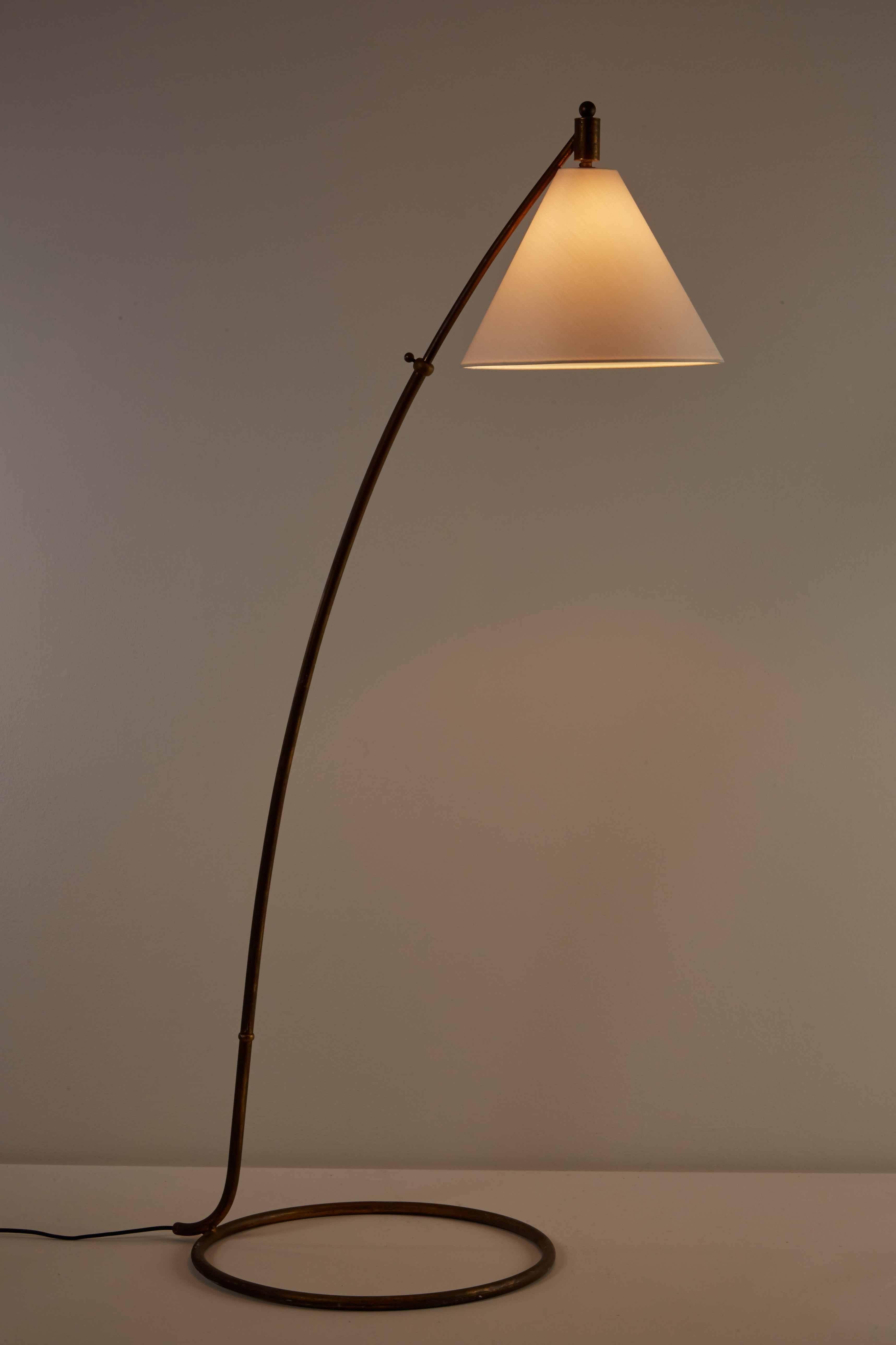 Floor lamp with brass base and custom silk shade designed in Italy, circa 1950s. Original cord. Takes one E27 75w maximum bulb.