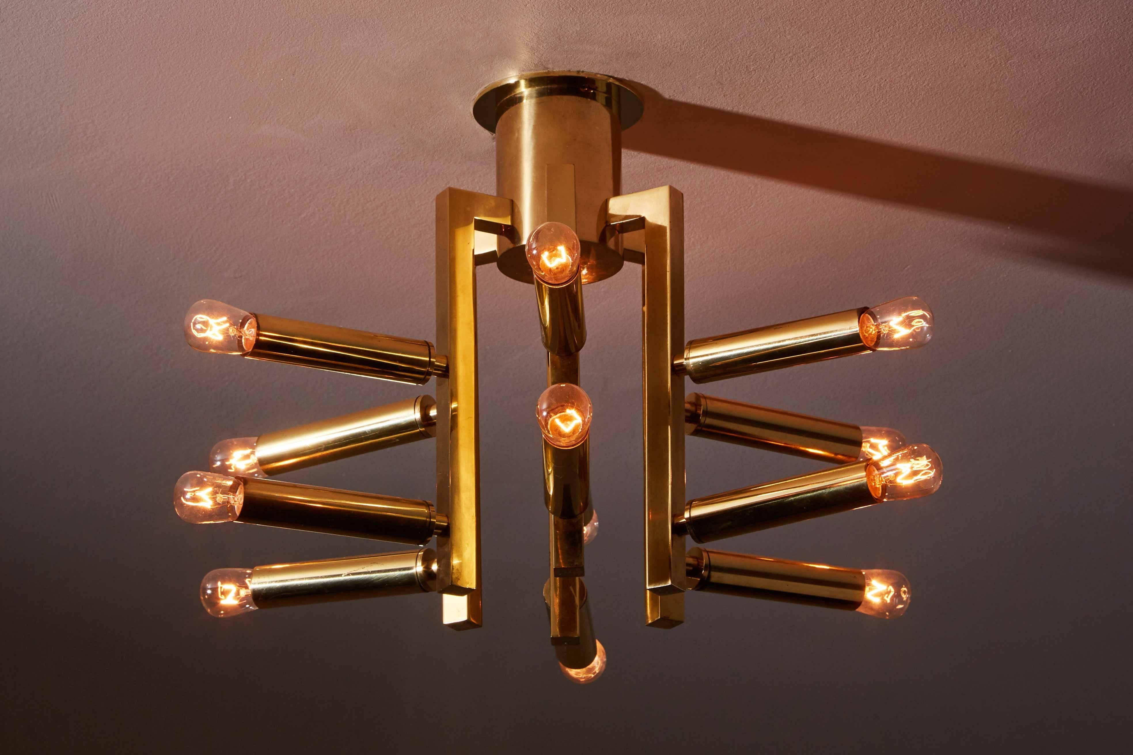 Brass twelve arm flush mount ceiling light by Sciolari designed in Italy, circa 1960s. Wired for US junction boxes. Takes 12 E14 European 25w maximum candelabra bulbs