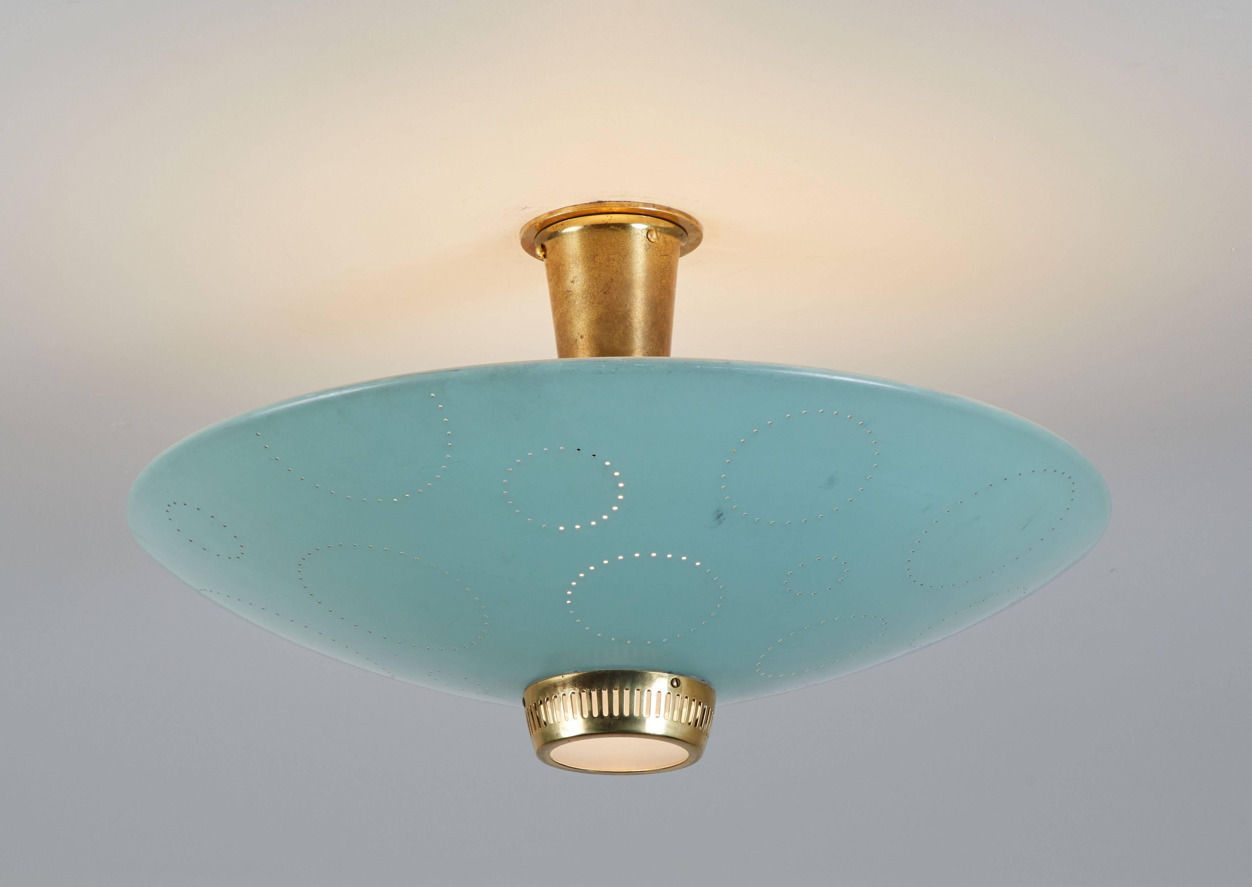 Flush mount ceiling light manufactured by Belmag, Zurich Switzerland, circa 1950s. Disc shaped enameled metal reflector with circular perforations of different sizes and a small round brass diffuser. Original colored enamel. Custom brass backplate.