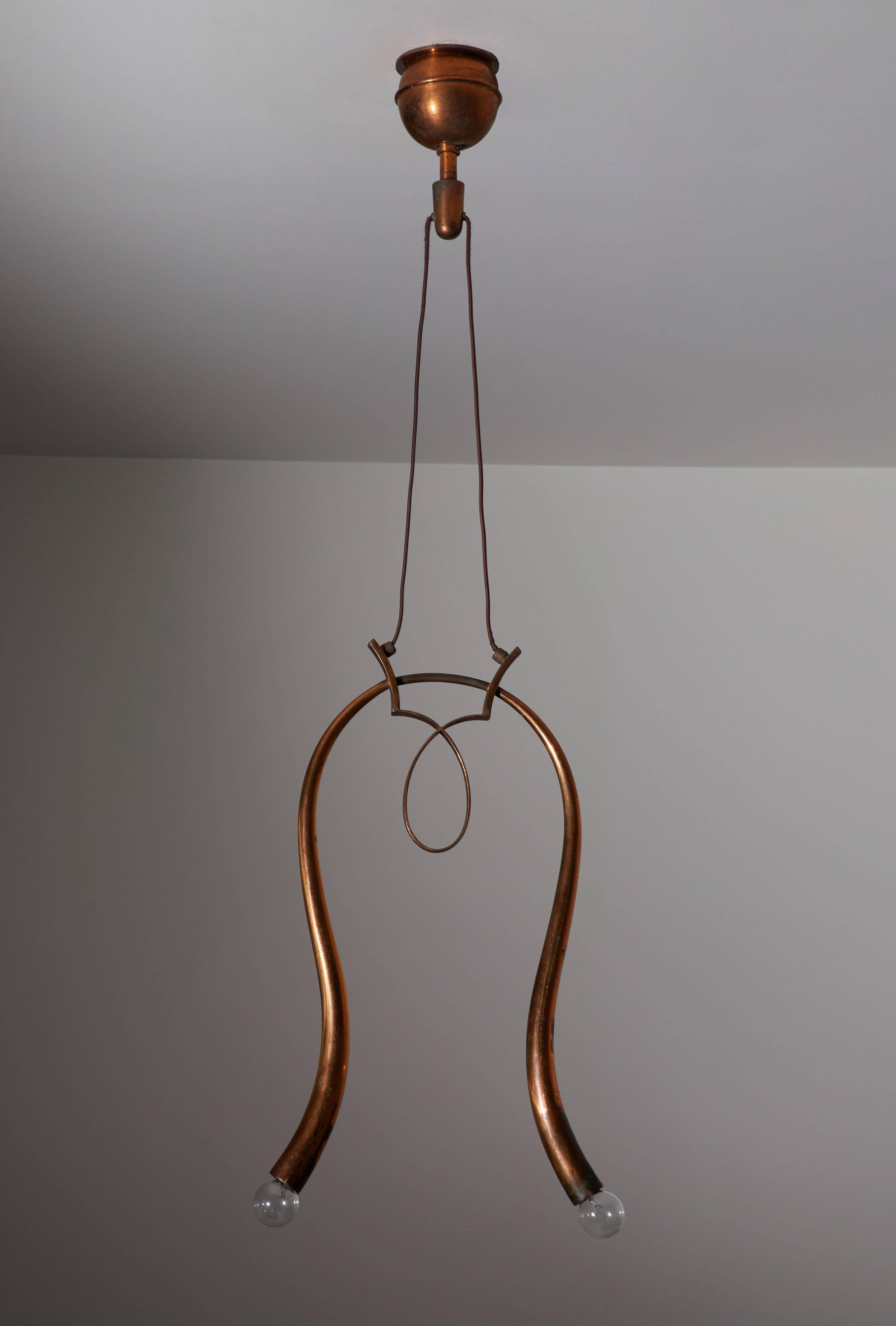 Elegant pendant designed in Italy, circa late 1930s-early 1940s. Brass with an exquisite copper colored patina. Wired for US junction boxes. Overall drop can be adjusted. Takes two E-14 60w maximum bulbs.
 