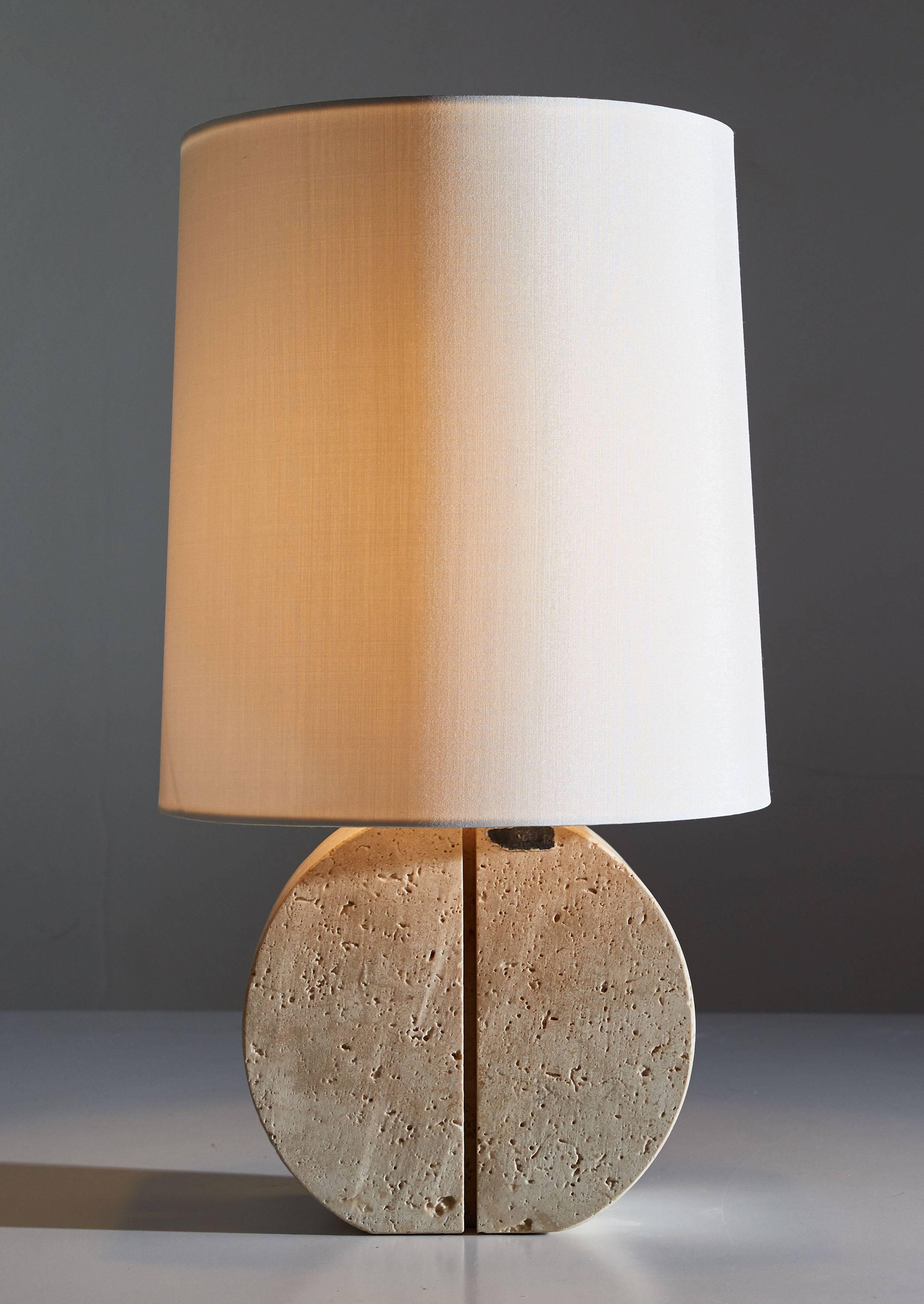 Travertine table lamp designed in Italy, circa 1970s. Linear carving to front and sides of travertine. Custom silk shade. Original cords. Maintains original label. Takes one E27 75w maximum bulb