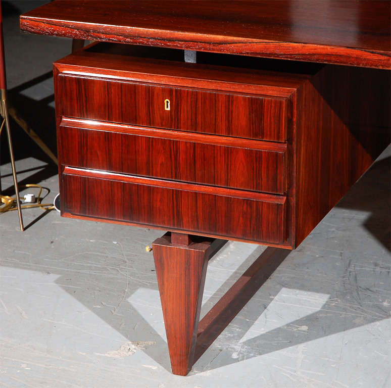 1950s Danish rosewood veneered 6-drawer desk with shaped legs.