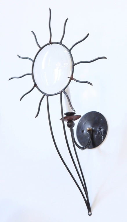 Andre Dubreuil pair of iron and copper sunburst wall sconces, circa 1986.
