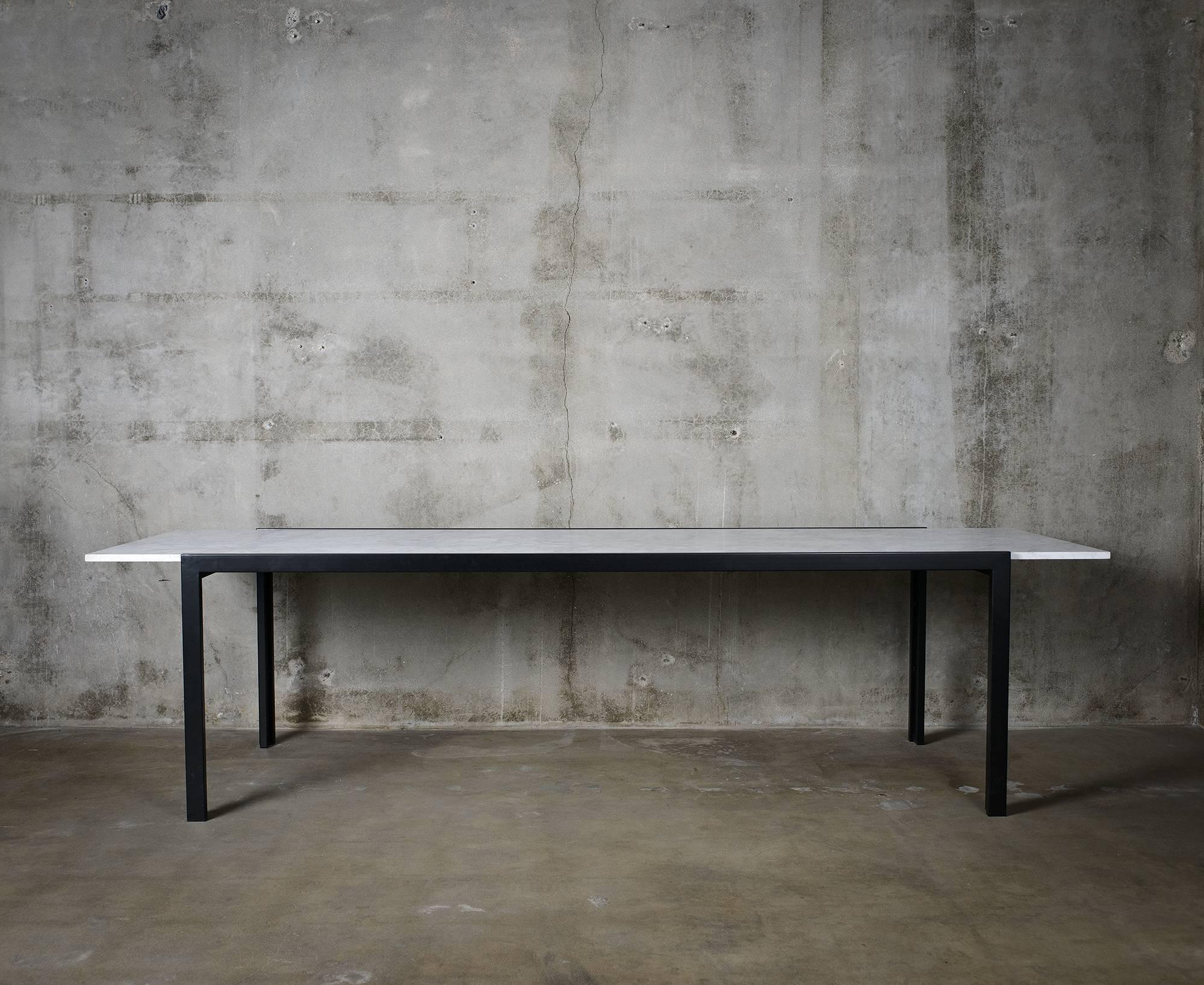 Marble-top and black steel based dining table, in the style of Van Keppel Green.