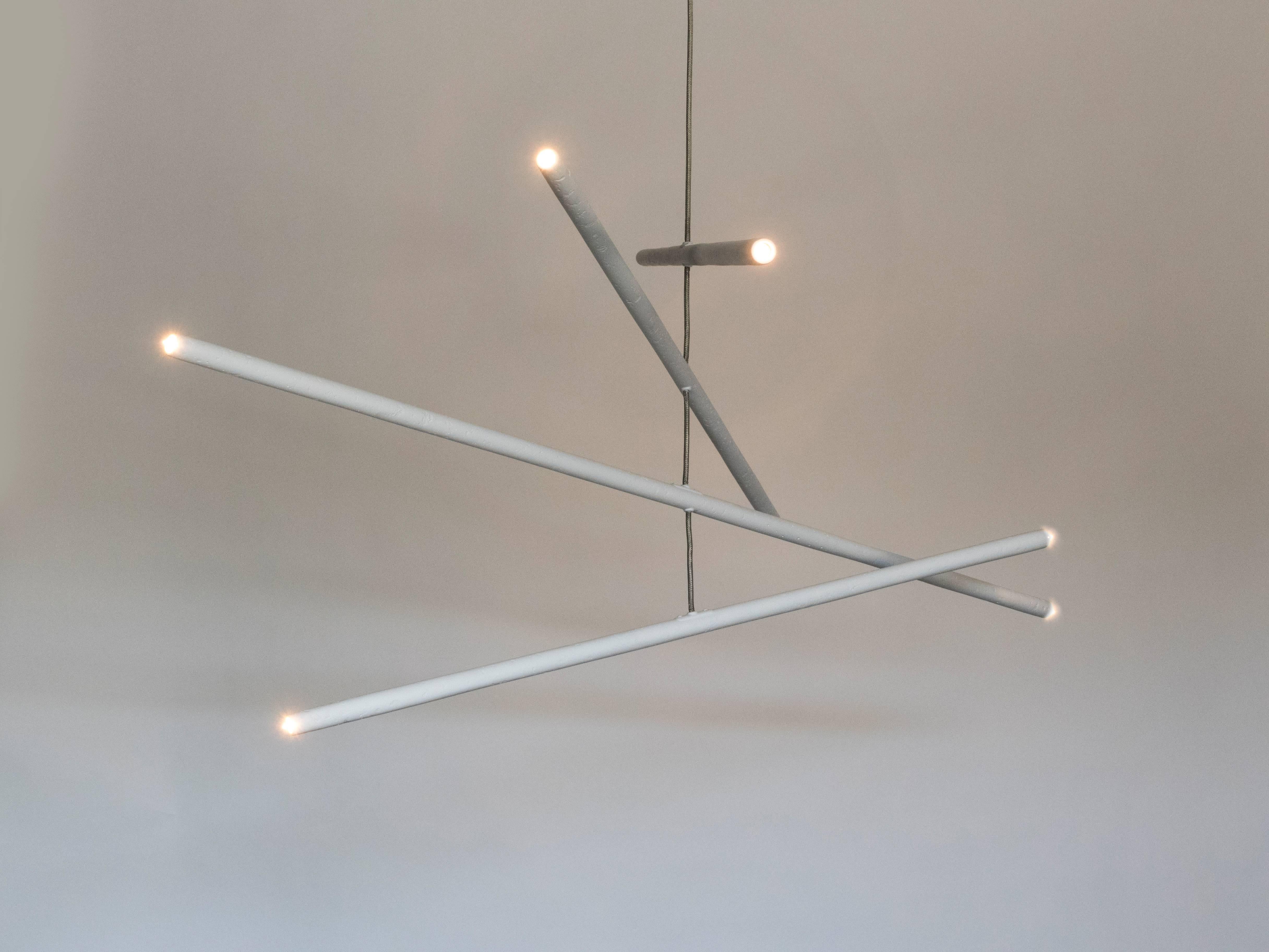 This intriguing chandelier floats in the air like a mobile. The hand finished plaster rods are fitted with low voltage halogen sockets and are suspended from low voltage wire. The eight lights provide a perfect ambience and light the room with a