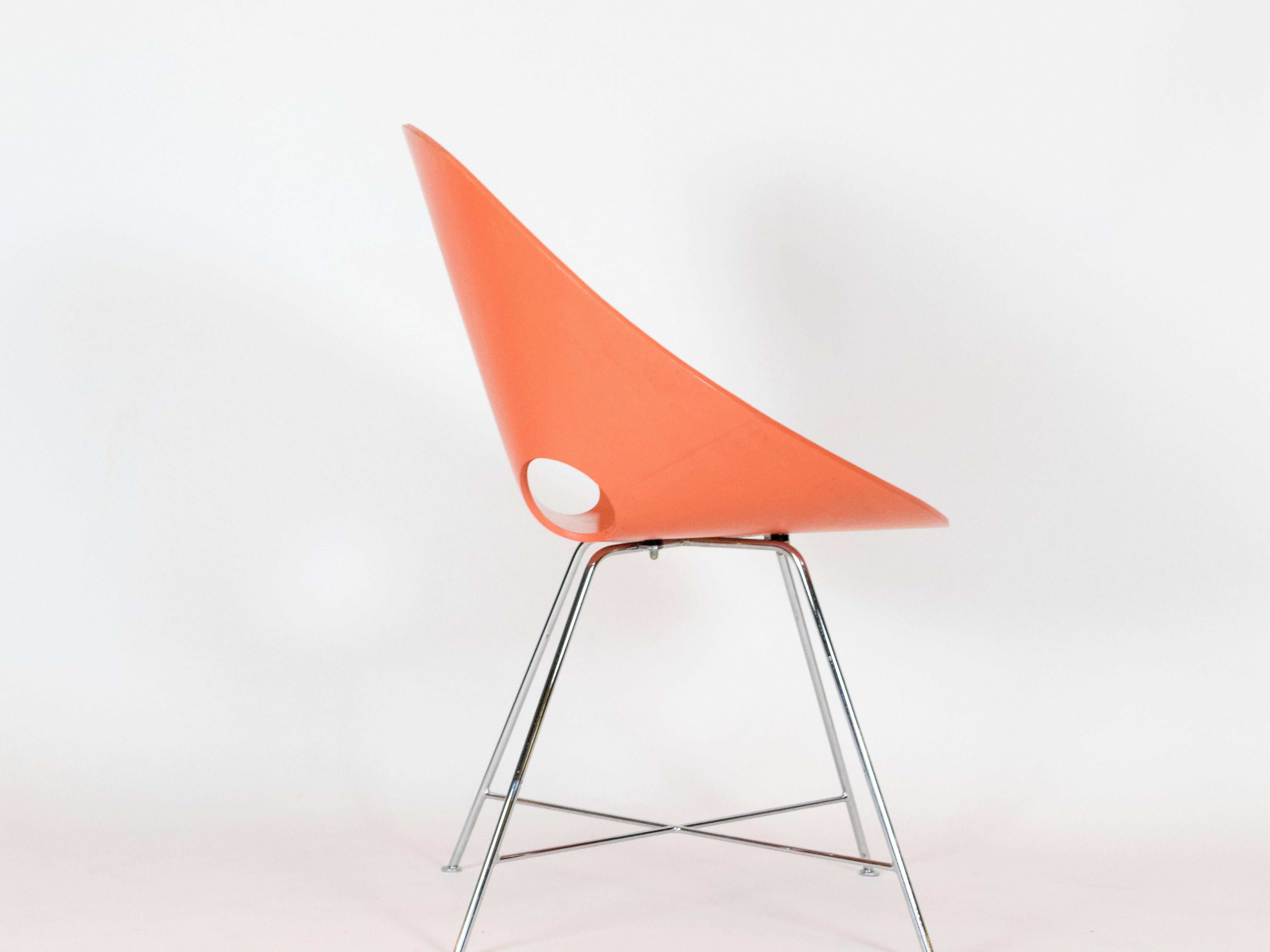 The ST 664 chair designed by Eddie Harlis in 1954. Thonet manufactured the chairs in Germany. These chairs are no longer produced. The two chairs, one in orange and other yellow are made from bent plywood (beech). The legs are chromed steel. In good