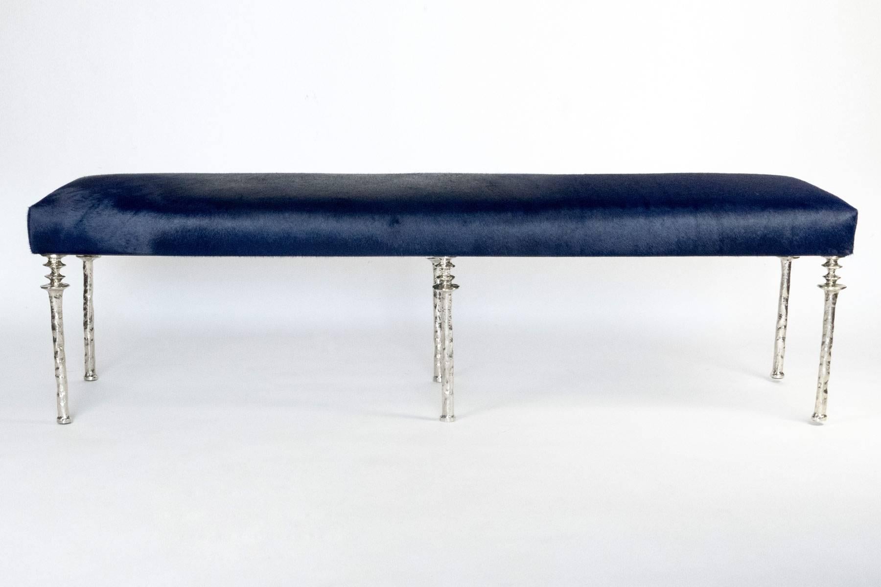 Inspired by Diego Giacometti, this bench are ideal for those who are looking for unique seating. Their cast bronze legs provide a truely organic touch. The
seat has been covered in a navy blue cow hide. This piece is in our showroom in the 1stdibs