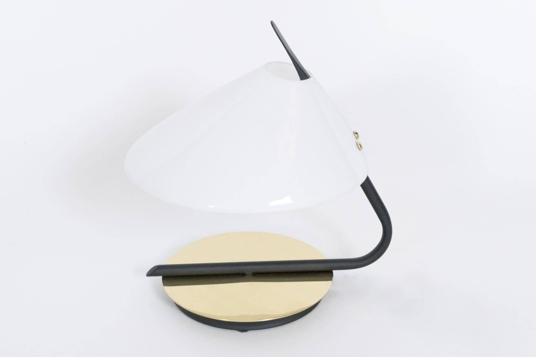 This small-scale lamp enhances shelves, small side tables or it fits about anywhere. The soft light which is diffused by the acrylic shade is accented by the reflection from the brass base.