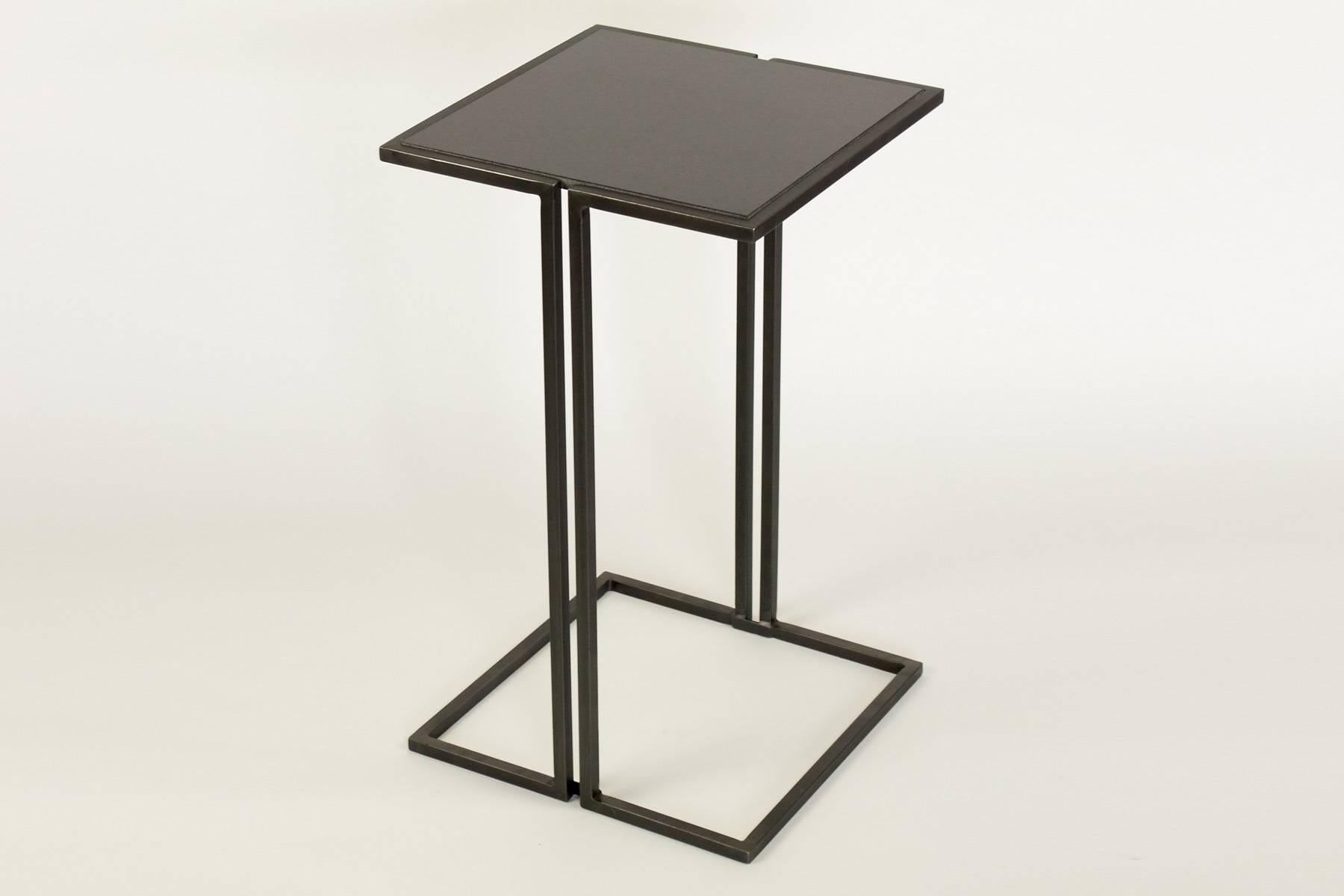 Two small-scale side table. Minimalist design with polished steel frame and black granite tops. Tables are in our showroom in the 1stdibs Gallery in NYC.