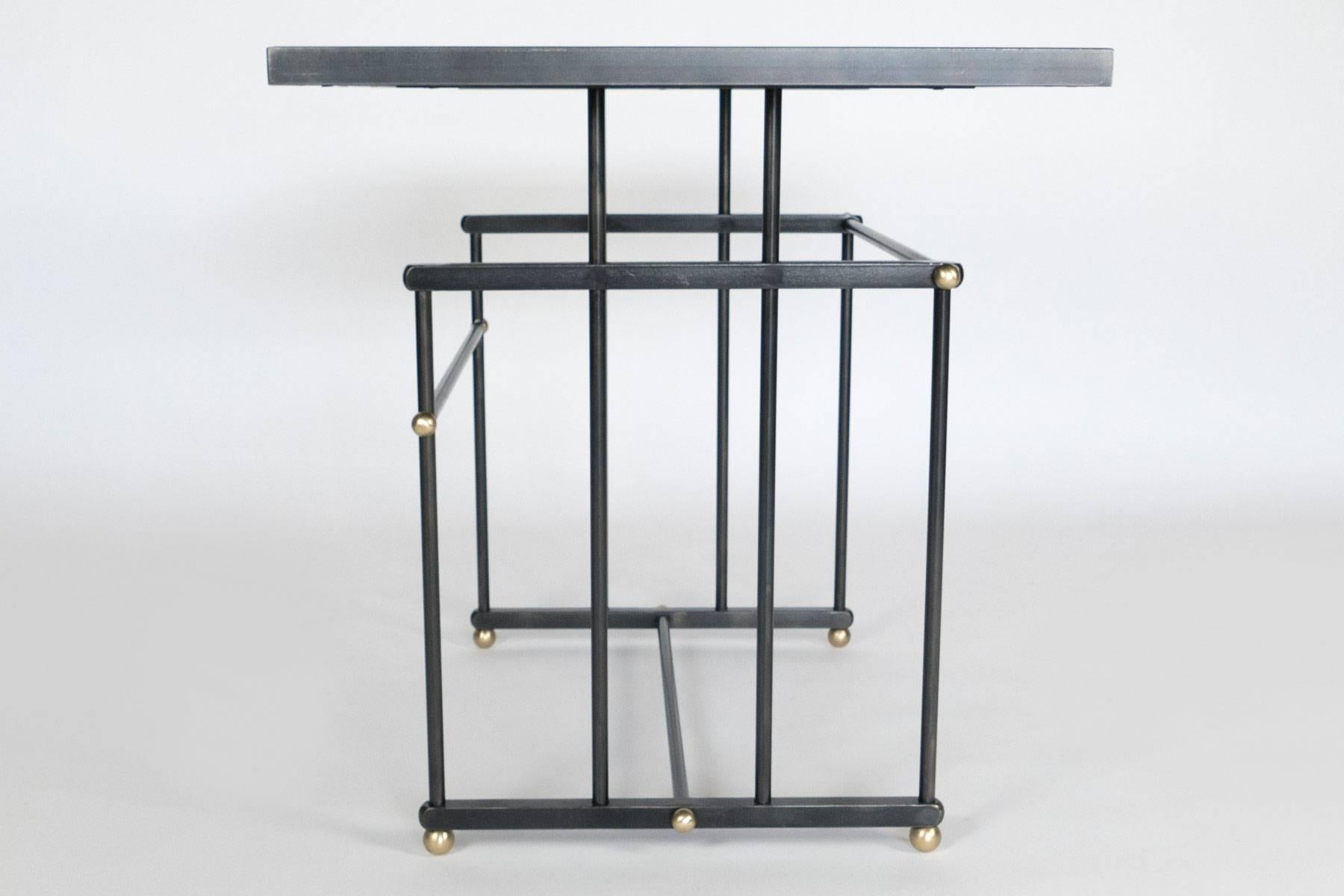 Two beautiful side table with a steel frame and brass accents. The tabletops are blue palisander veneer. A matching console table is also available. Tables are located in our NYC showroom in the NY Design Center at  200 Lex.