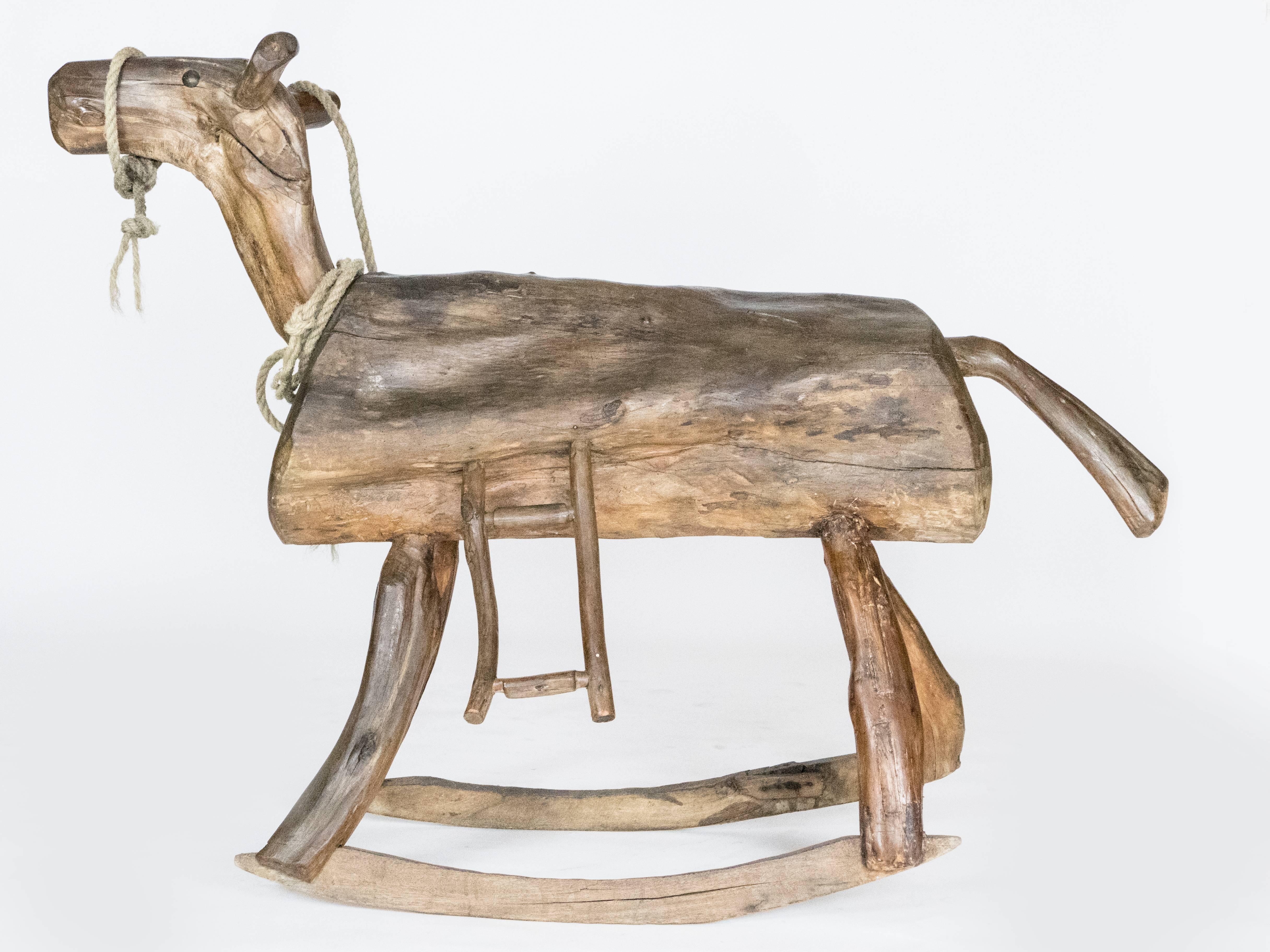 This adult sized rocking horse is a unique find. An artist has crafted this piece from a log and branches. Solid frame.