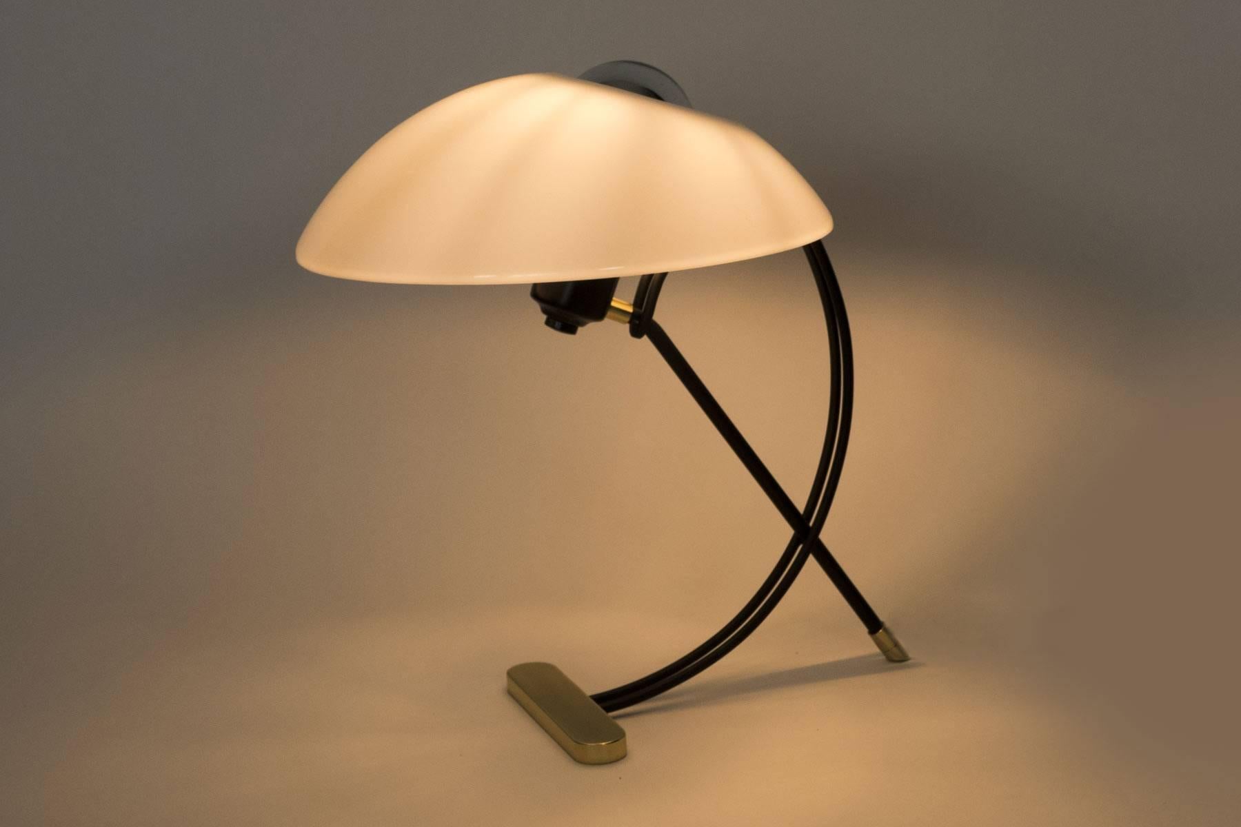 This stylish table lamp is a nice blend of the basic midcentury elements, brass,
acrylic and black enamel. This midcentury inspired lamp provides a beautiful light. The details of the frame add to the elegance. Light uses on medium based bulb.