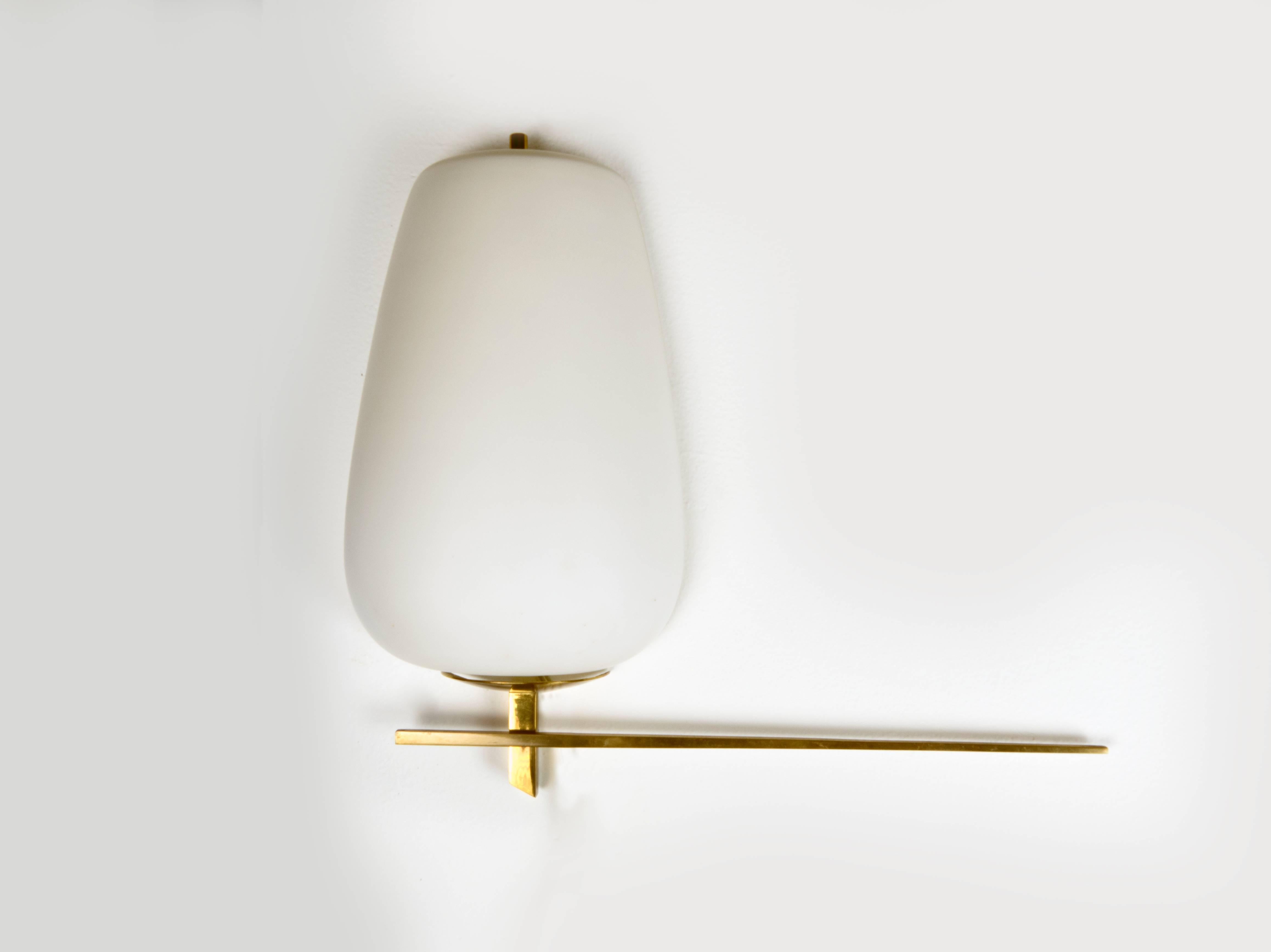 This charming sconce has a delicate brass frame and an opaline half shell diffuser.  The light provides a delicate light, works well over a standard J Box, and has had the socket replaced to a standard candelabra based bulb,  Max wattage 60 watts. 