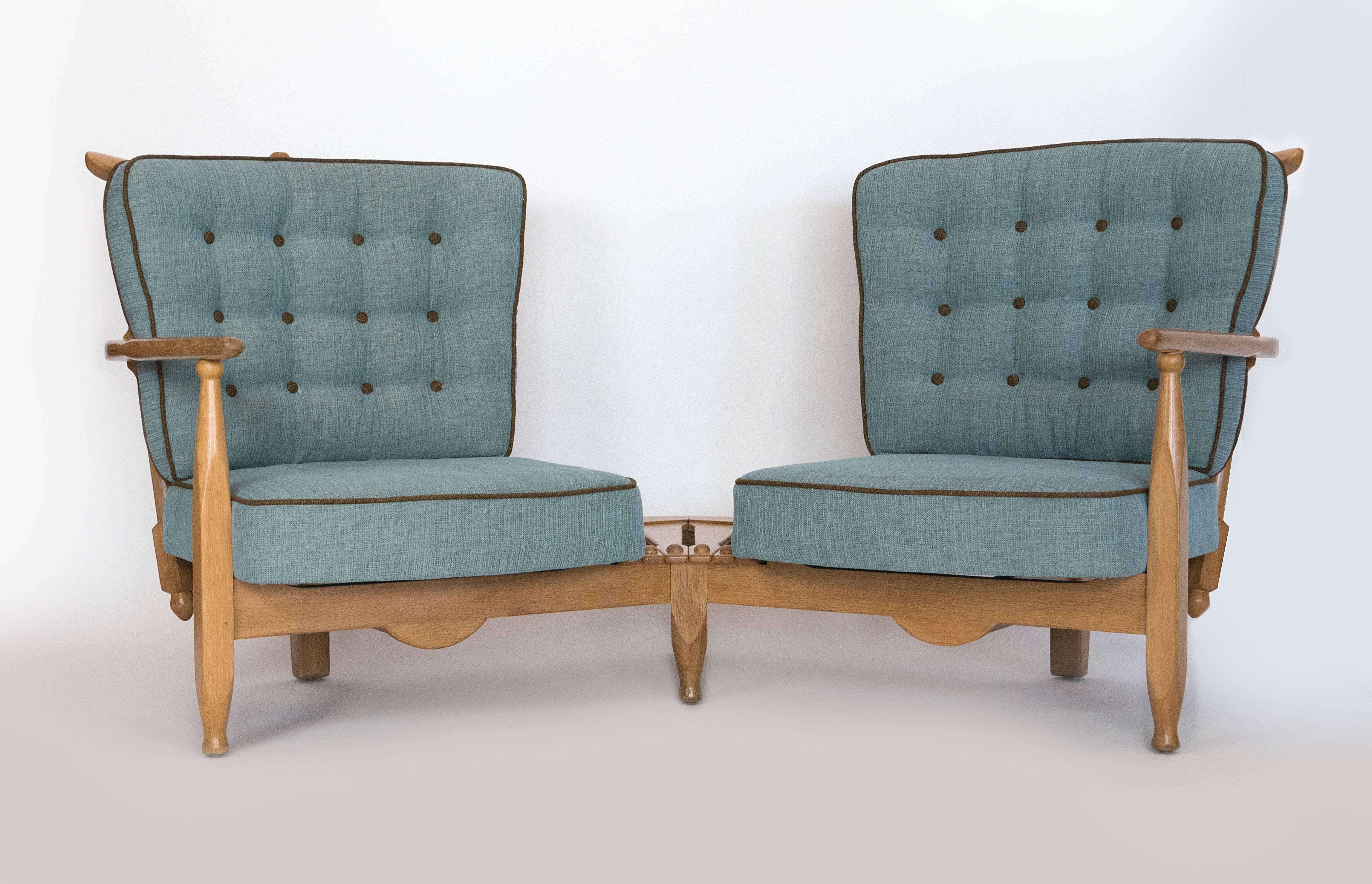 Very comfortable and unusual piece by the French design team of Guillerme et Chamborn for Votre Maison,  Crafted in the late 1950's this oak settee has great lines, and their signature turn oak stylings.  New upholstery work has been done.  