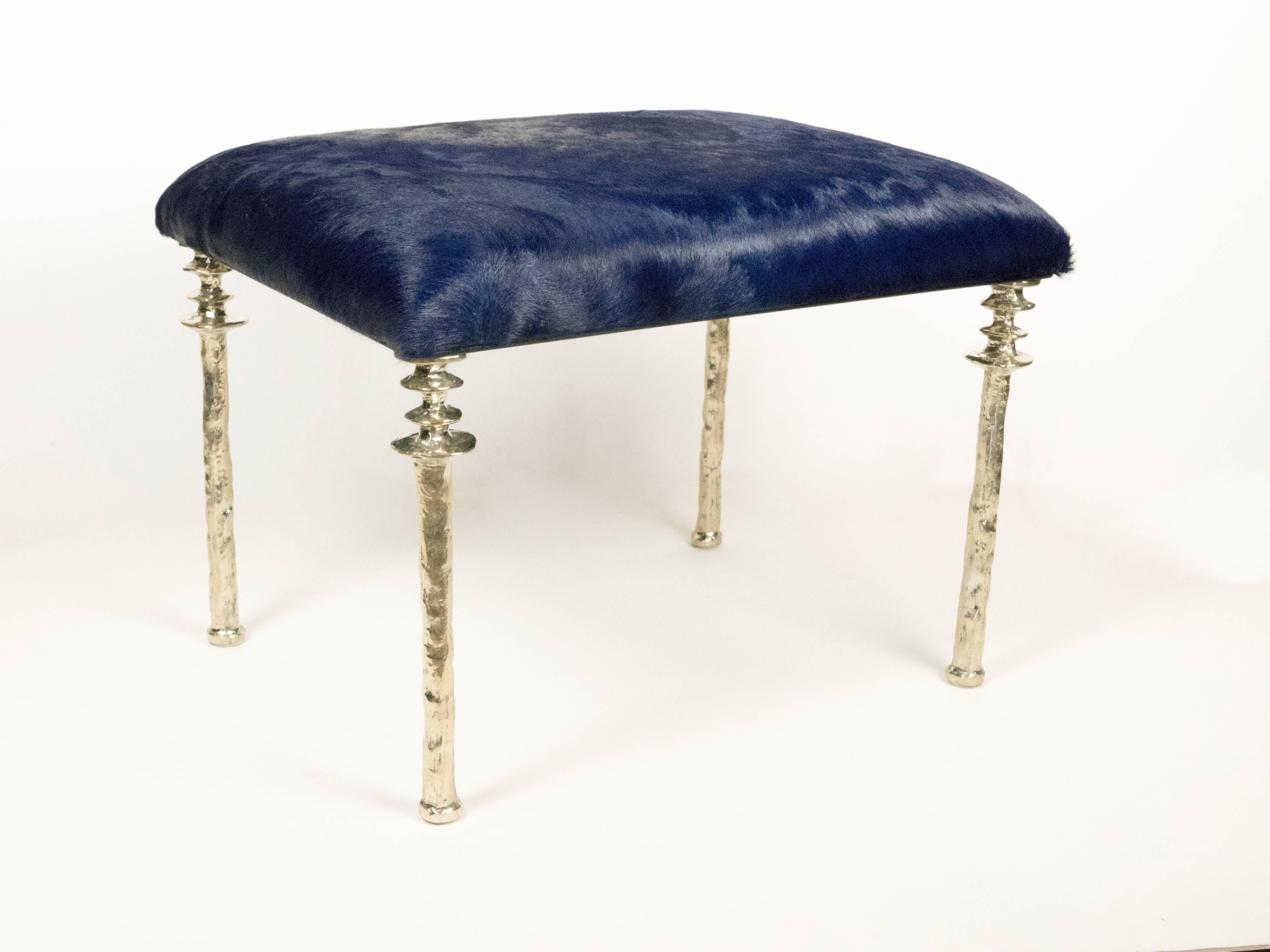 Two beautiful stools inspired by Diego Giacometti, these stools are ideal for those who are looking for unique seating. Their cast white bronze legs provide
a truely organic touch. The seat cushion has been upholstered in a navy blue
cow hide.