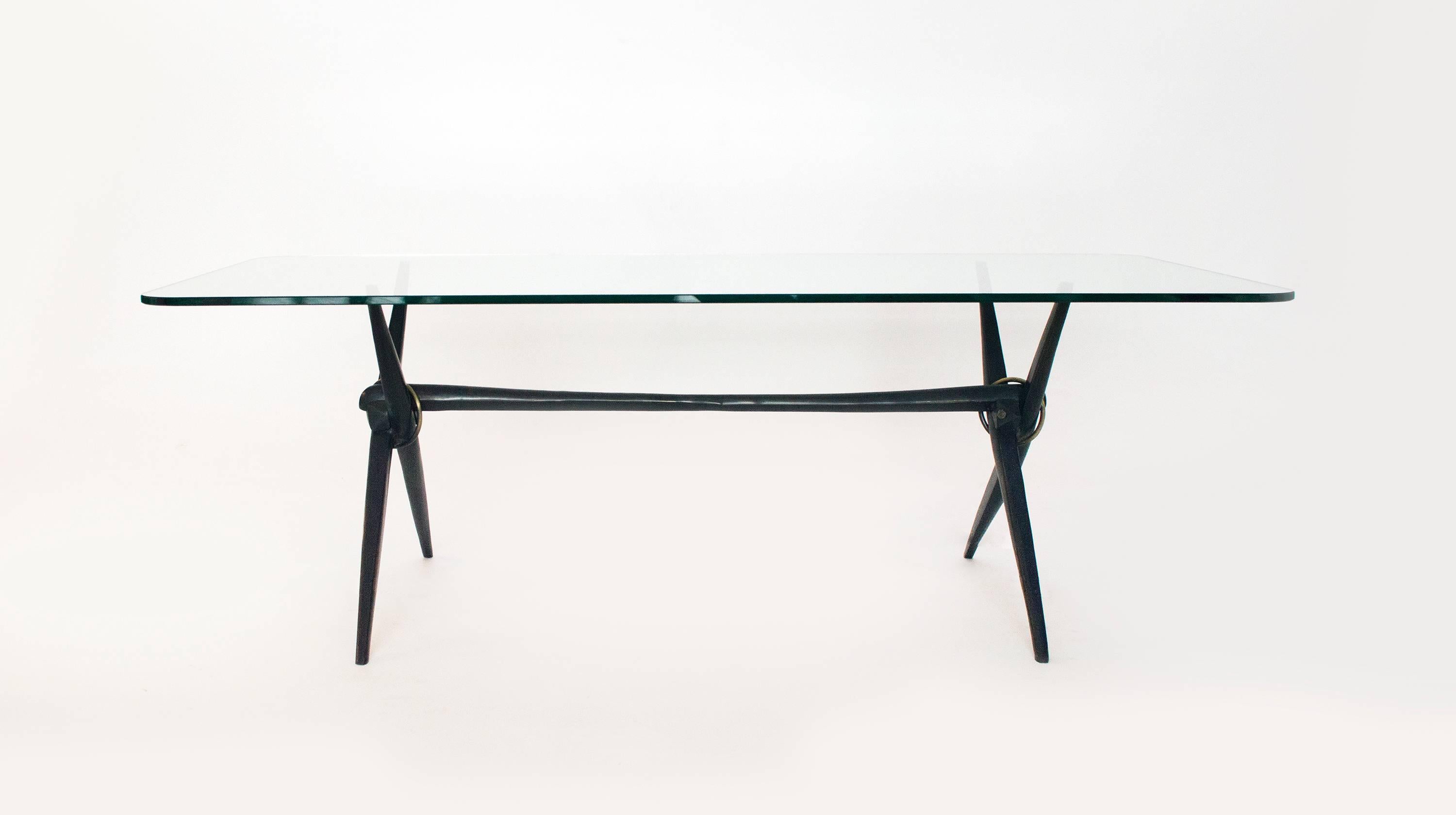 Being cast in solid bronze, this table stands apart from your typical table. It works well as a low side table or as a small coffee table. The elegant tapered legs are bound by a brass band where they intersect with the third tapering cross member.