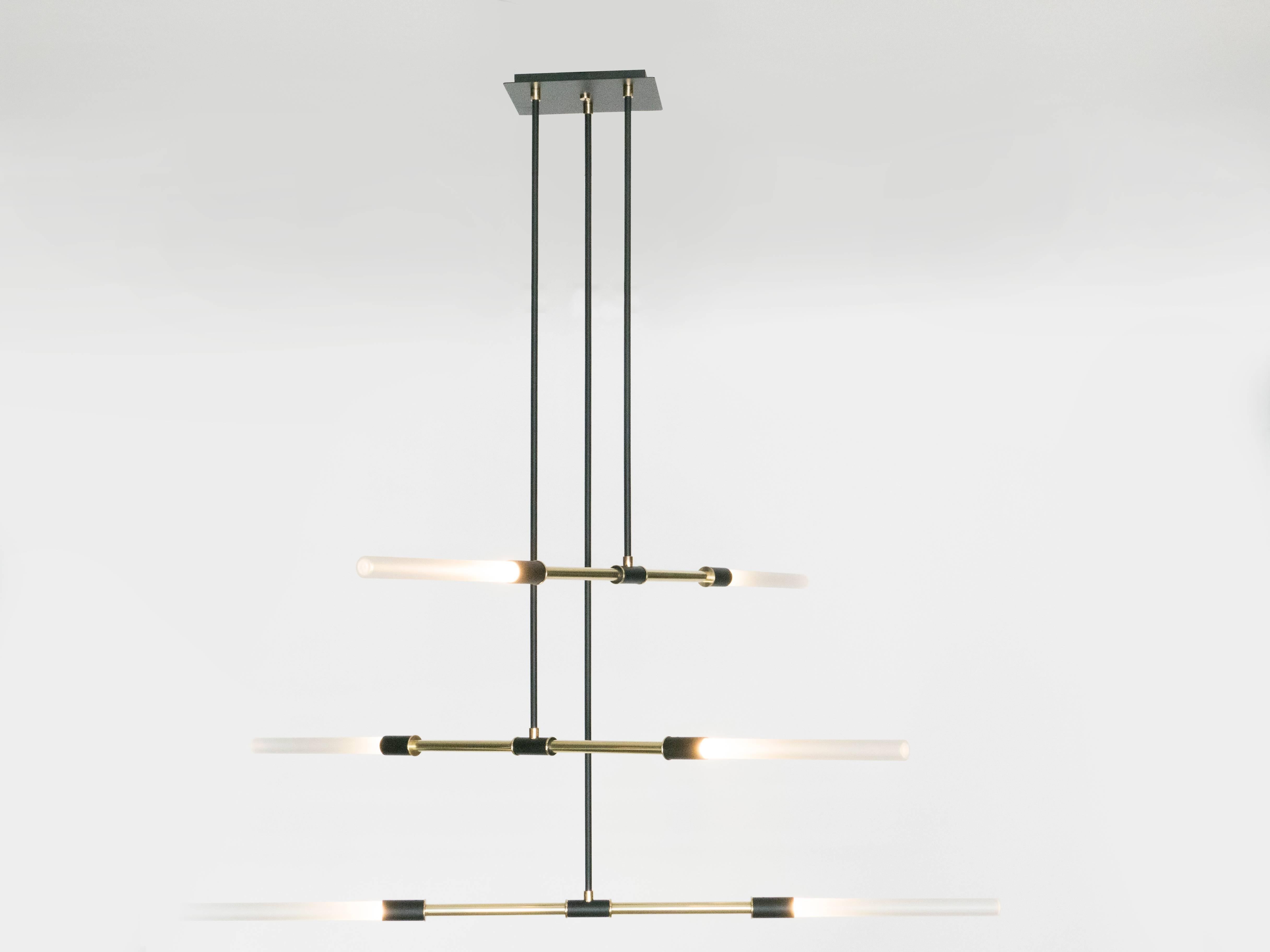 The focal point of this impressive chandelier are the six frosted handblown glass swords which shot out light in different angle. The mix of brass, frosted glass and black enamel finish come together to create a large-scale chandelier which diffuses