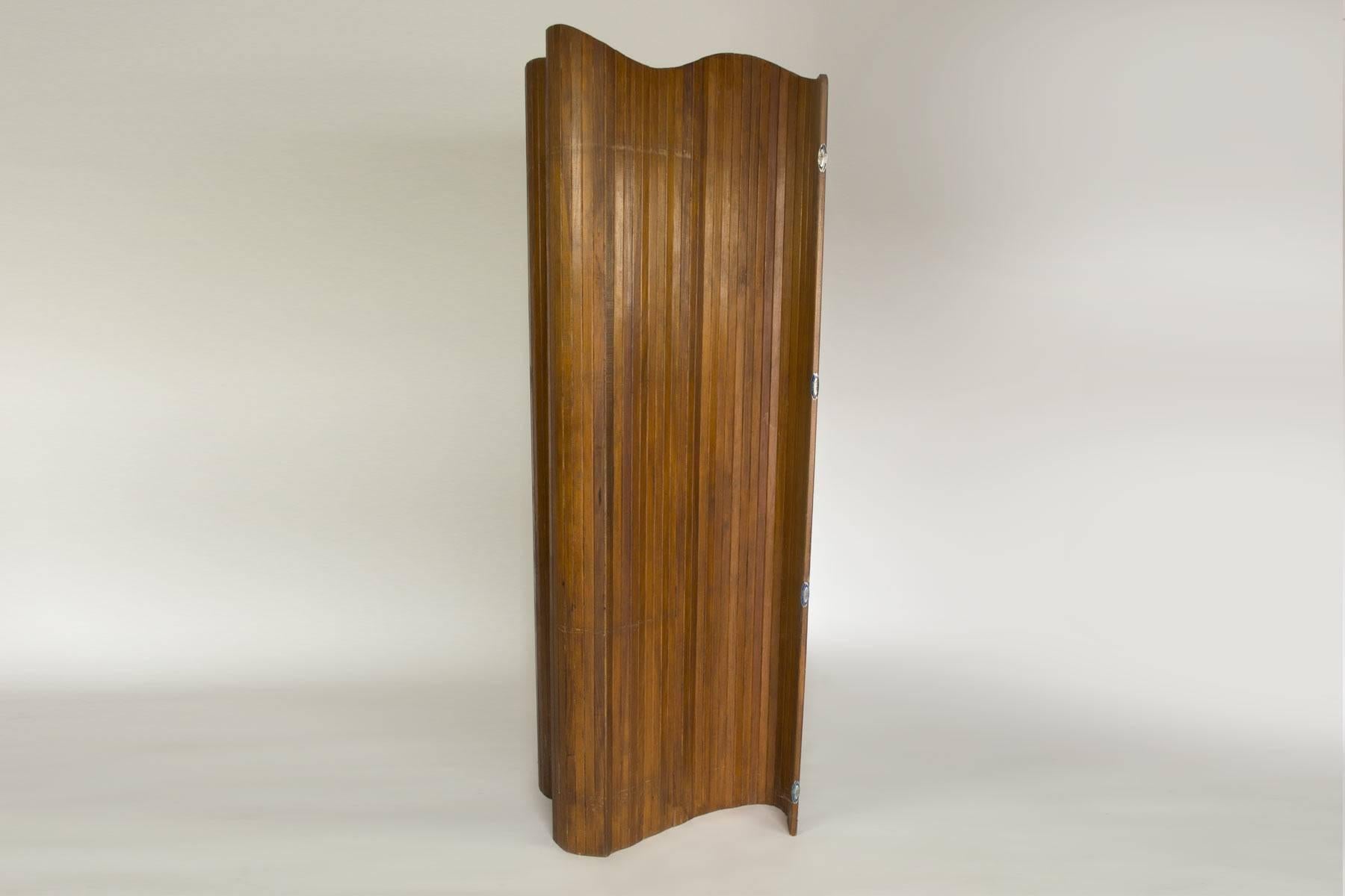By Duremail, Toulouse, France, circa 1950. This screen made from rattan provides for an excellent room divider. It is light weight and the flexible design allows for great versatility. The warm wood tone blends well with all decor. This item in in