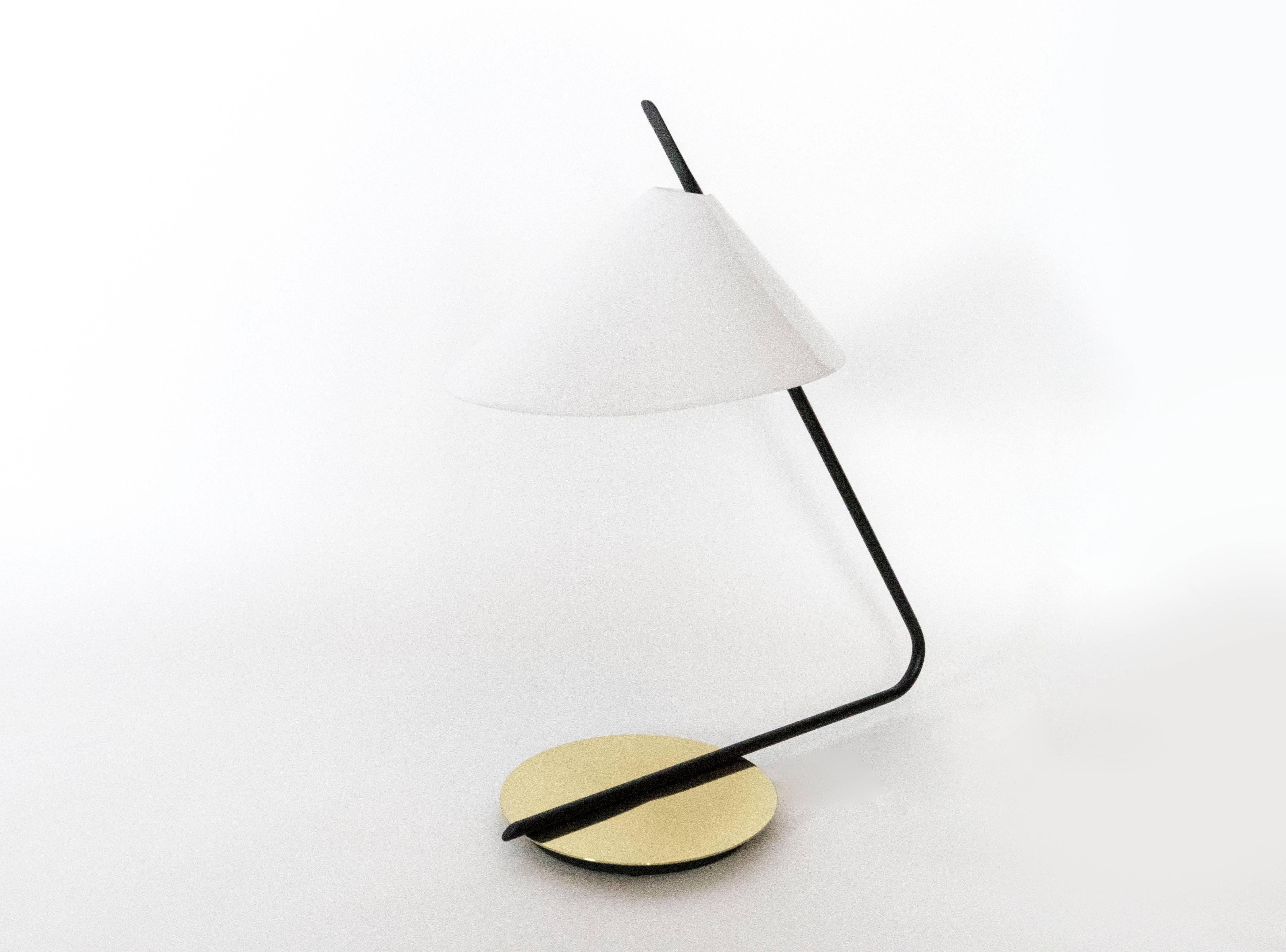 This lamp was scaled to work perfectly as a desk lamp, bedside lamps, or on an end tables. The soft light which is diffused by the acrylic shade is accented
by the reflection from the brass base.
