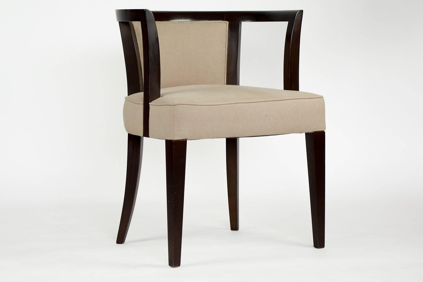 Two armchairs with a dark walnut stained frame. The seats and backs have tan linen upholstery work. Chairs are located in our showroom in the NY Design Center at 200 Lexington Ave.
 