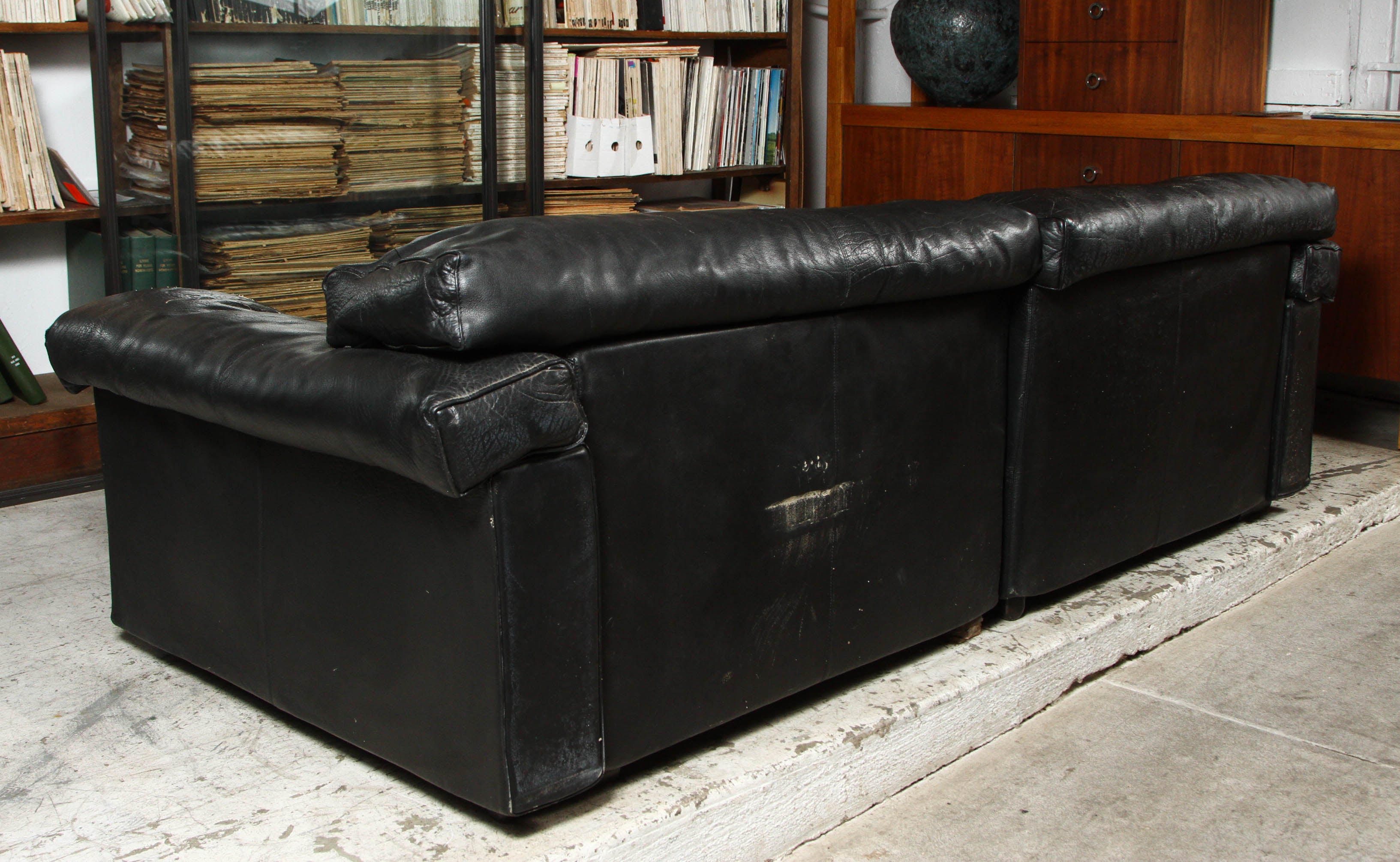 Black leather sofa with a nice worn in look. Designed by Tobia Scarpa for B & B Italia.
