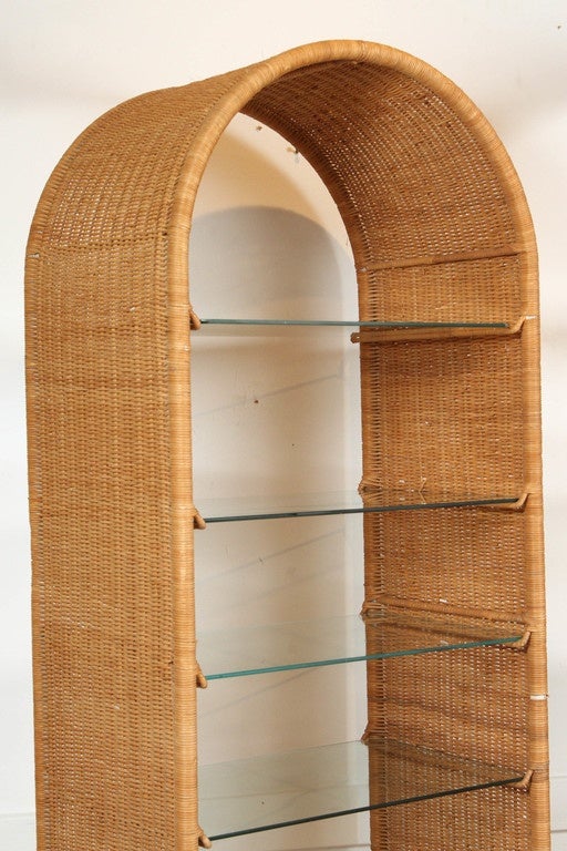 Pair of wicker etegeres with glass shelving by Danny Ho Fong for tropical.