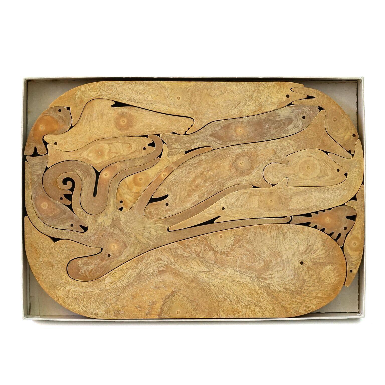 Enzo Mari created this puzzle for Danese. The puzzle is made of expandable resin made to look resemble wood. The title is 