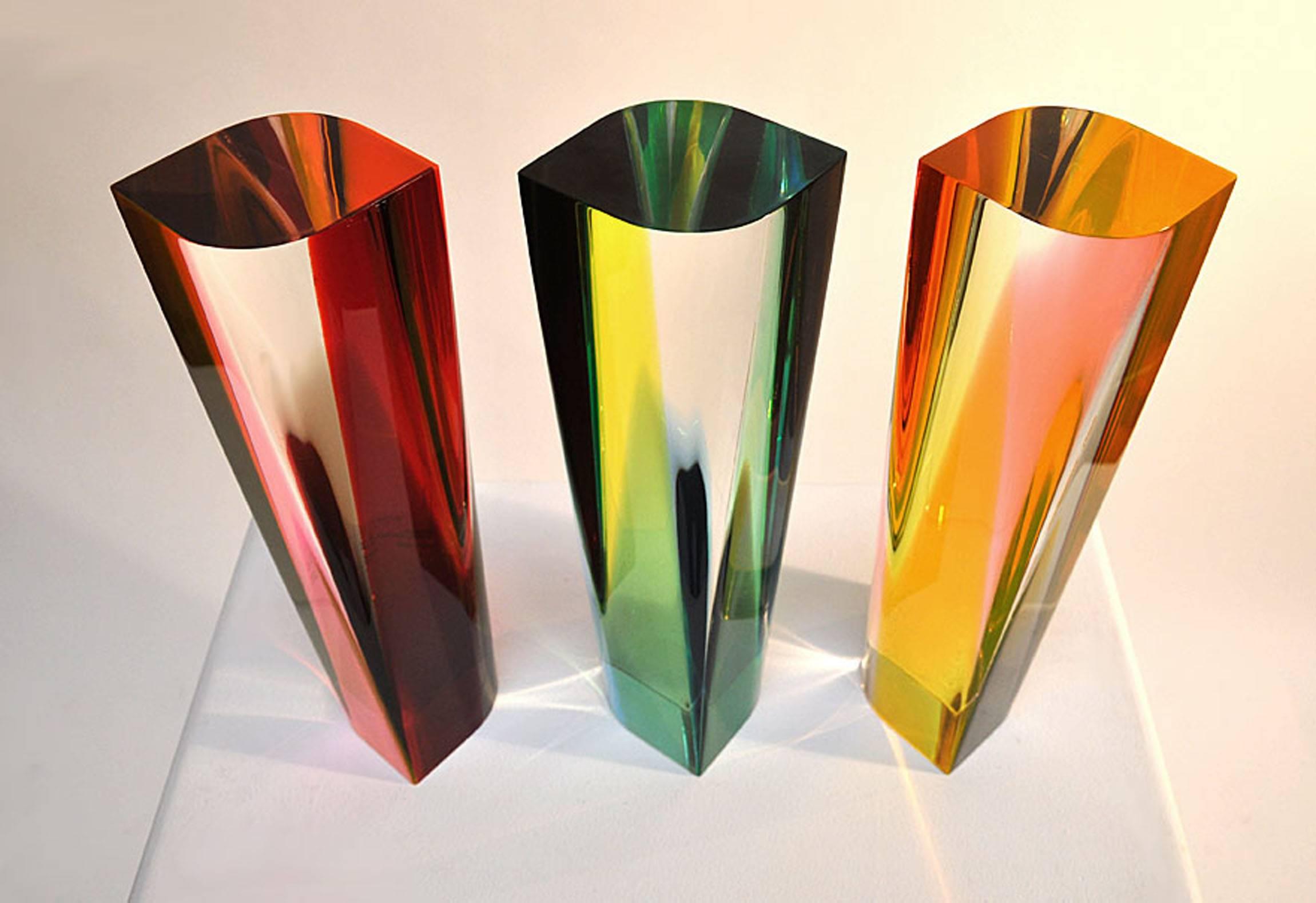 Three-piece solid cast acrylic fine art sculpture signed: M. Jones 1976. The colors change depending on the perspective. Dynamic modern sculpture. Price is for the three pieces.