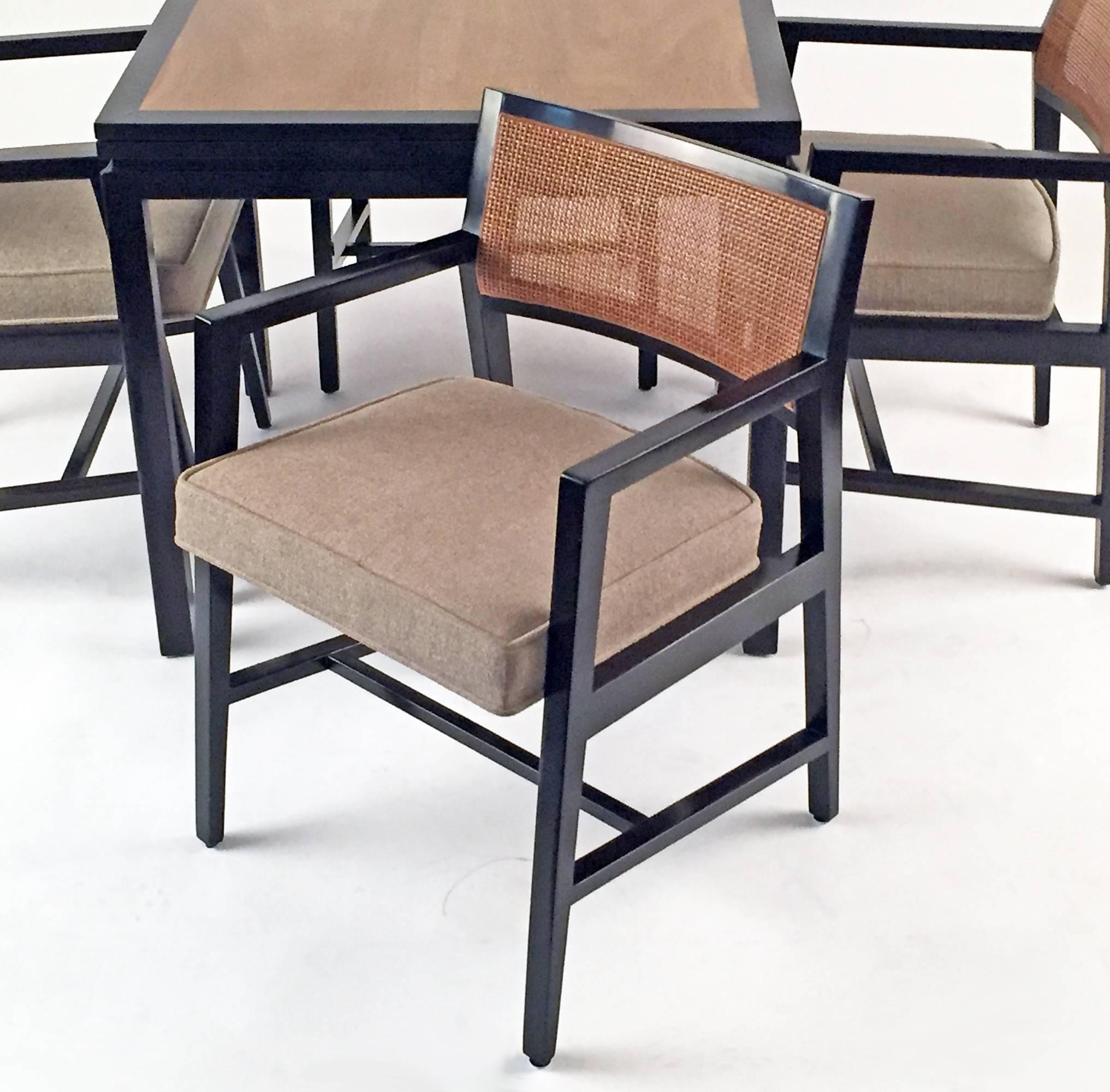 Flip-top table and four chairs designed by Edward Wormley for Dunbar Furniture, Berne, Indiana. Retains the original D gold Dunbar tag and order tag. When flipped open, the table doubles in size. 32