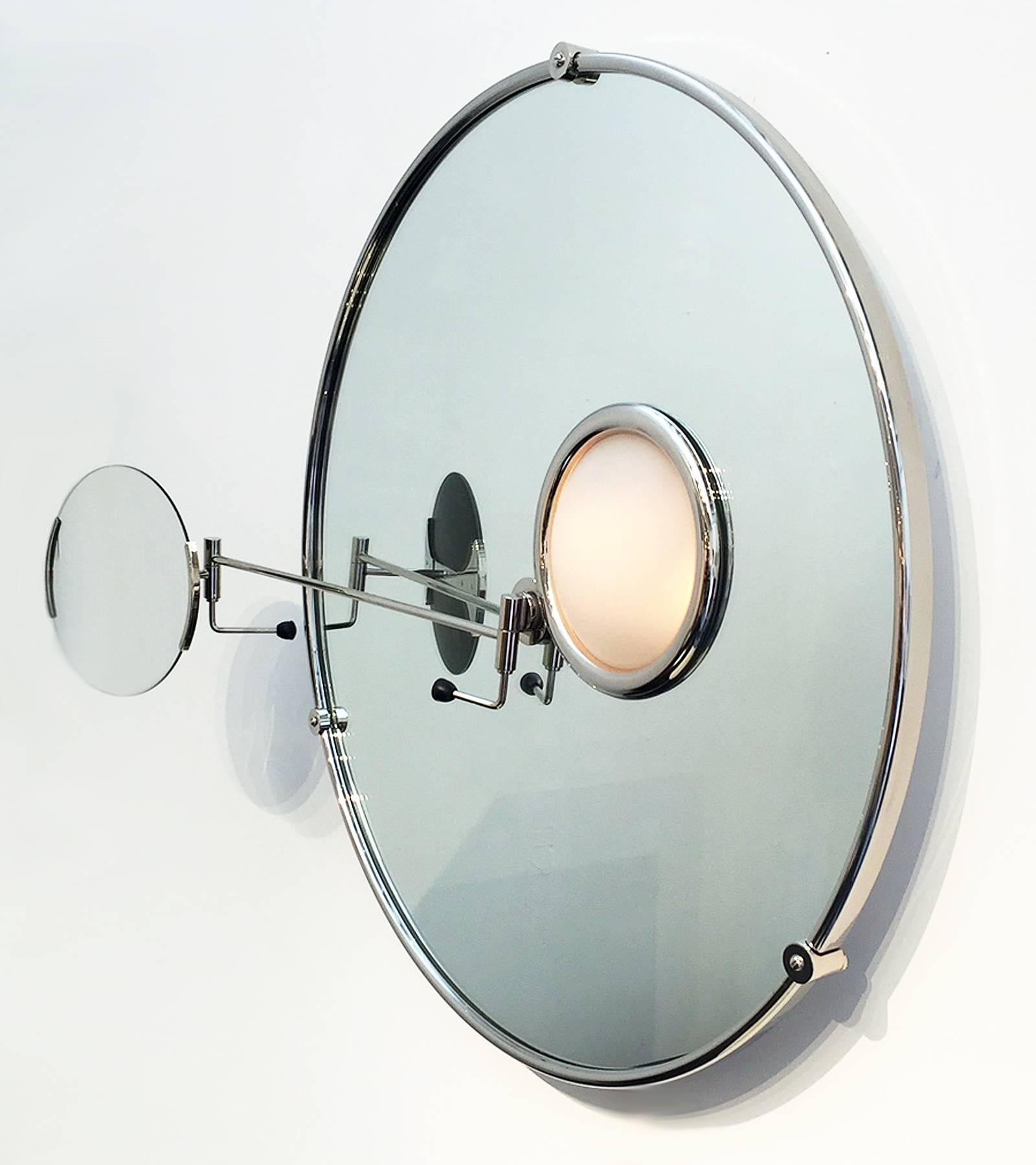 Eileen Gray created this satellite mirror for her home in the South of France, 1927. This is a current production made of nickel plated brass and glass. Illuminated portion has a sand blasted glass cover. Features an adjustable magnifying mirror