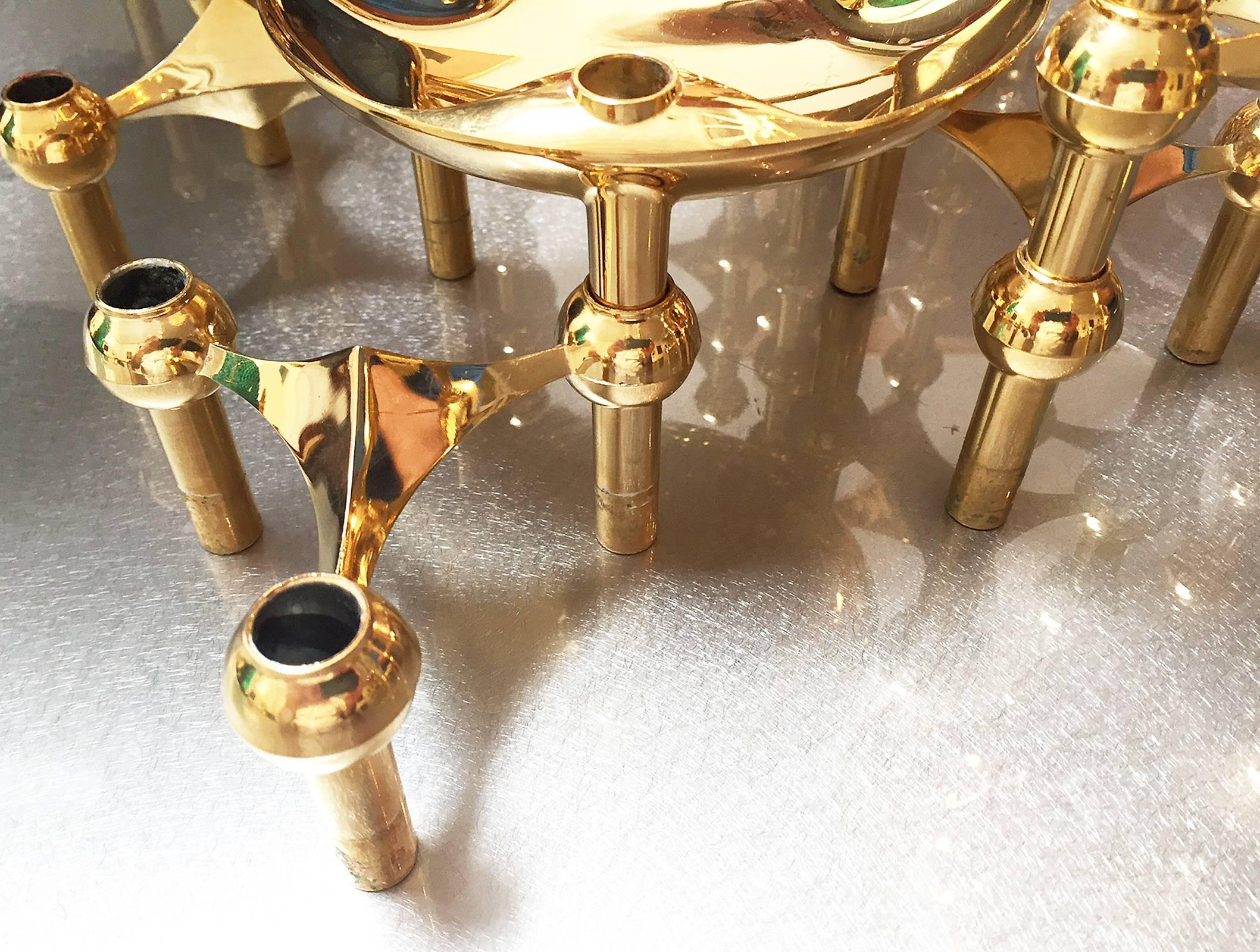 Brass candleholder system. 28 sculpted brass pieces can be separated or connected in an endless combination of arrangements. Use all of the pieces together for a centerpiece or individually. This set includes two shallow bowls. Made by BMF, Germany,