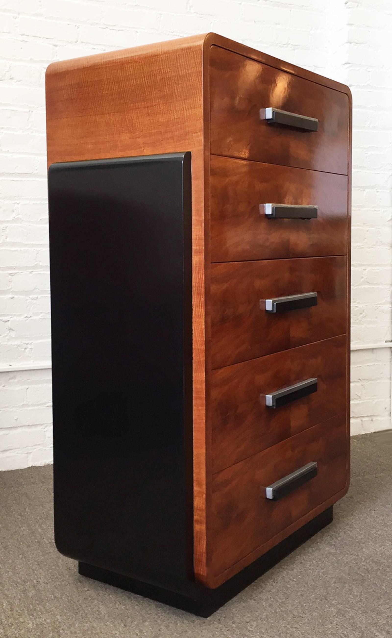 Tall dresser designed by Donald Deskey for Widdicomb Furniture, 1930s streamline design. Features bookmatched flame walnut drawers with signature Deskey metal and wood handles. The finish has been expertly restored. Price is for the tall dresser